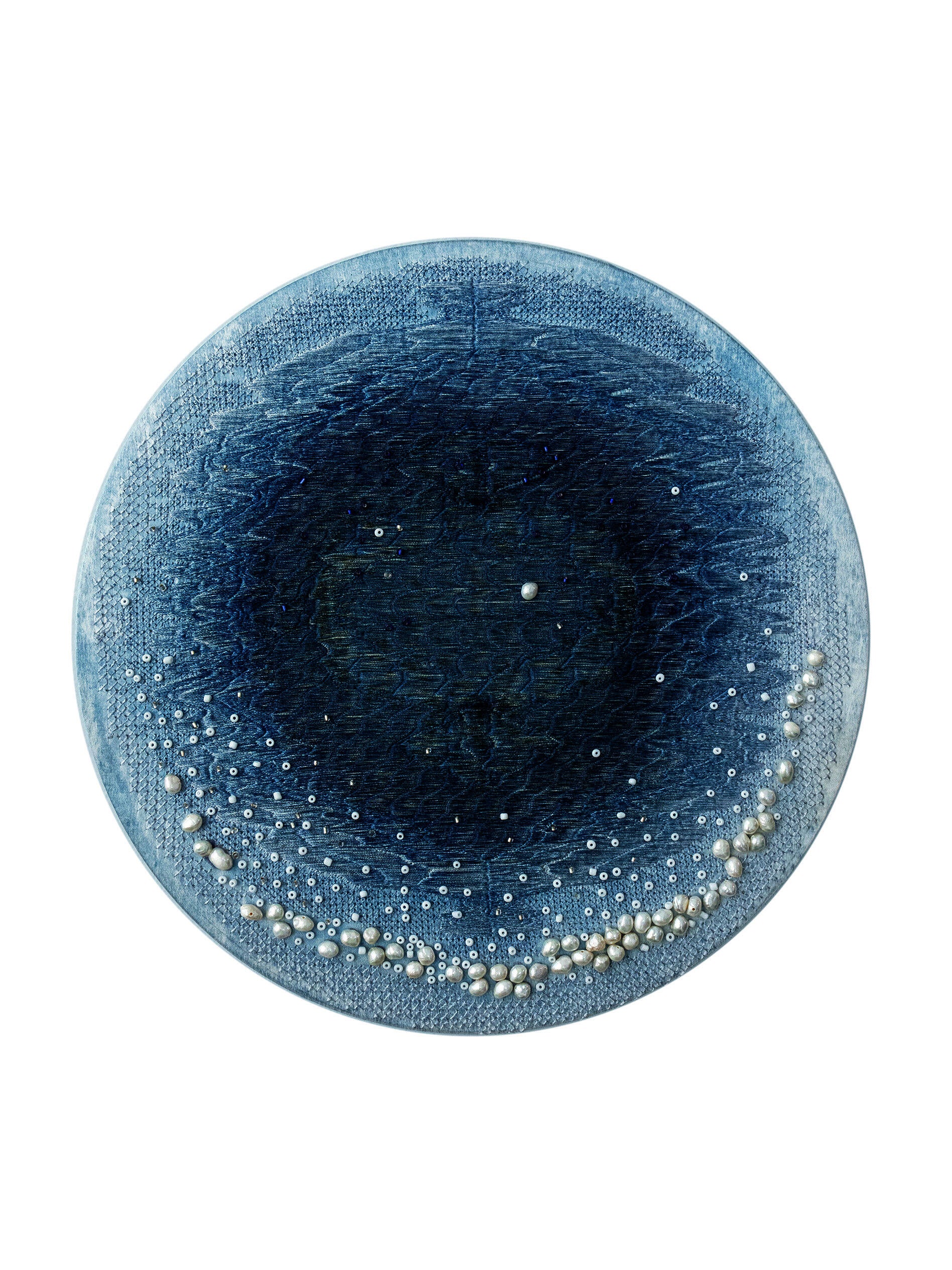 On a silk dyed light blue, I used embroidery and beadwork to create a pattern similar to the blue hole of the ocean.