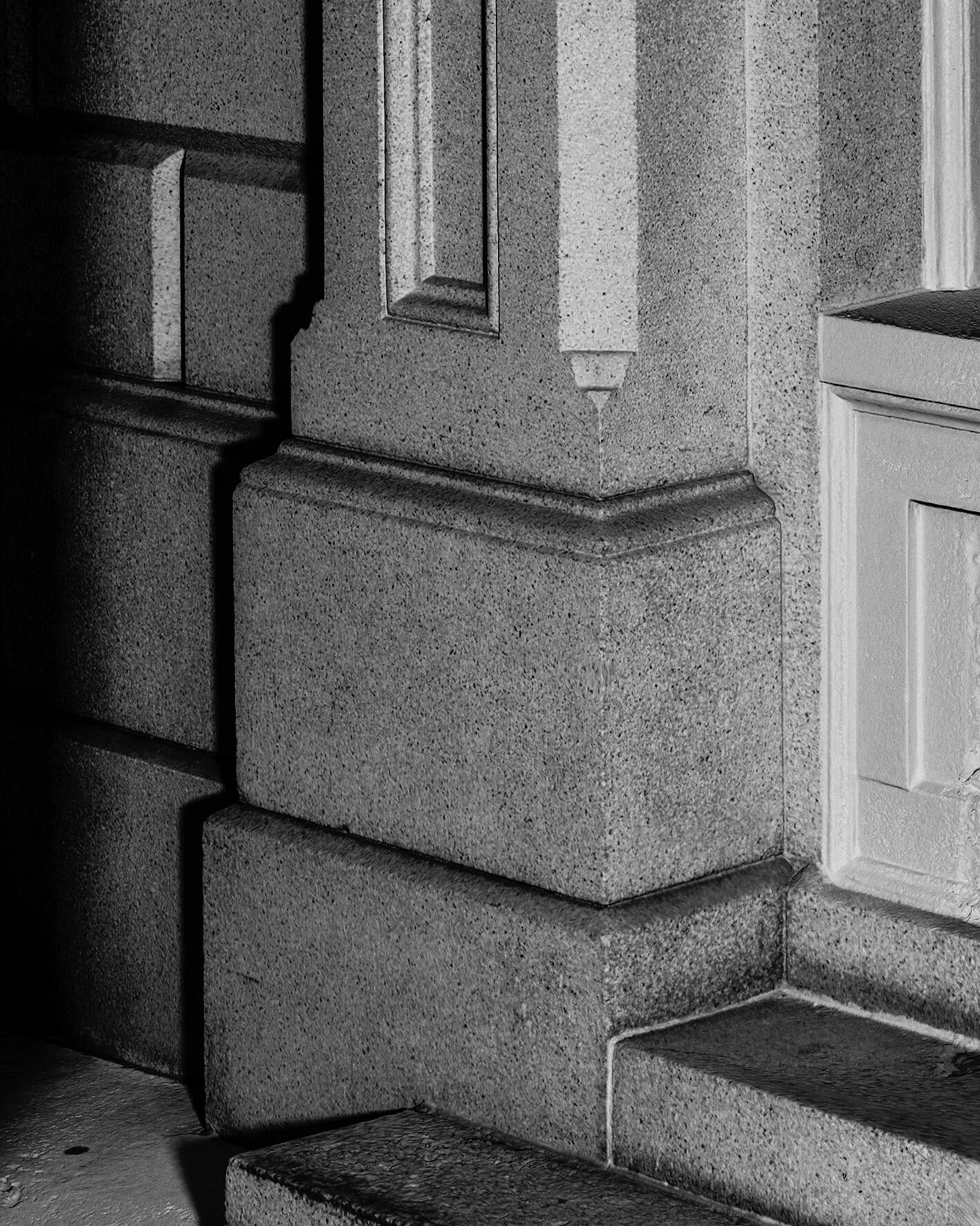 A black and white photogrammetry scan of the side of a building made of large granite slabs.