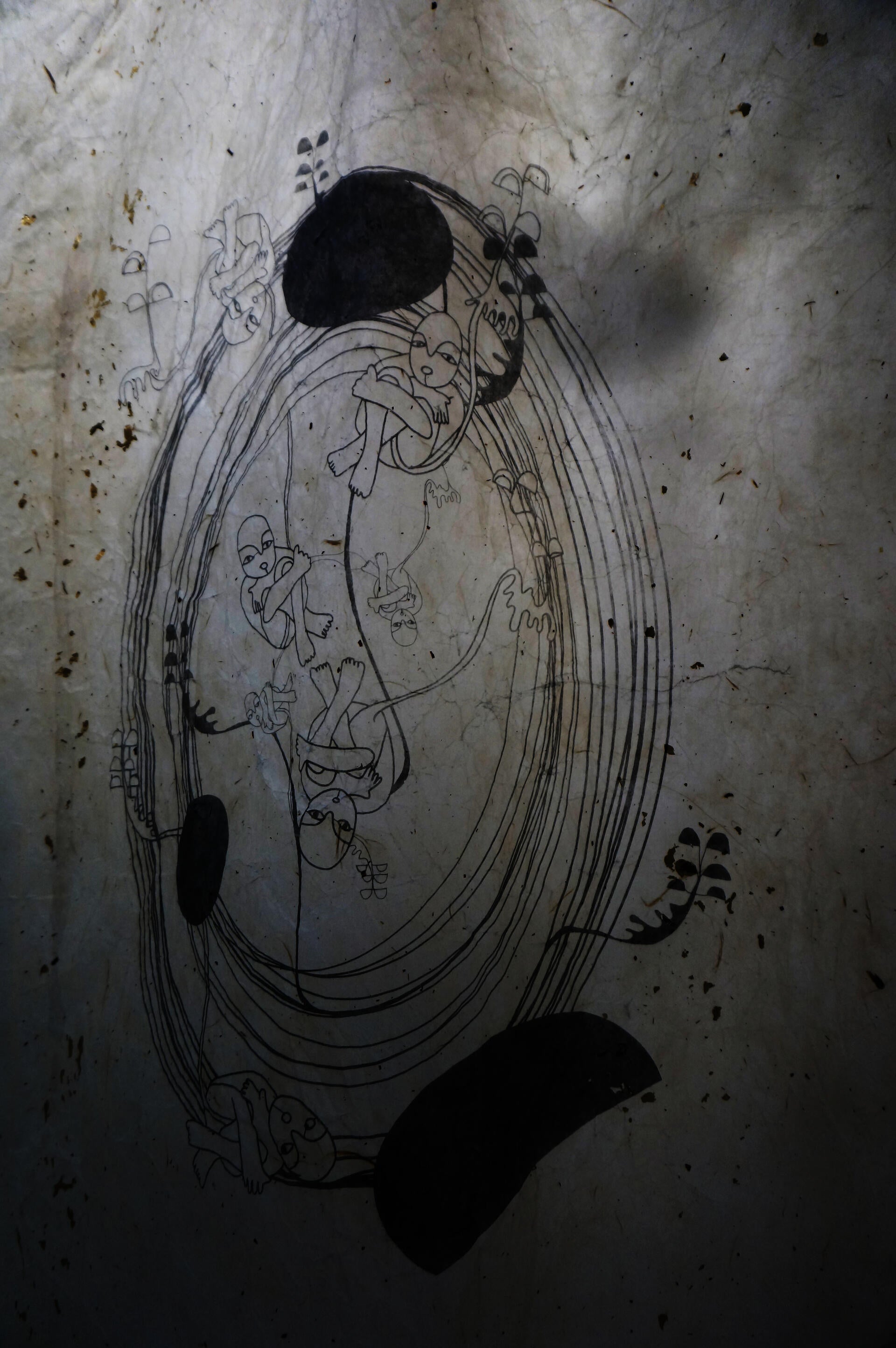 We can see close up of the image. . The figures are all connected with the umbilical cord, floating weightless in the space of the womb-like circle.