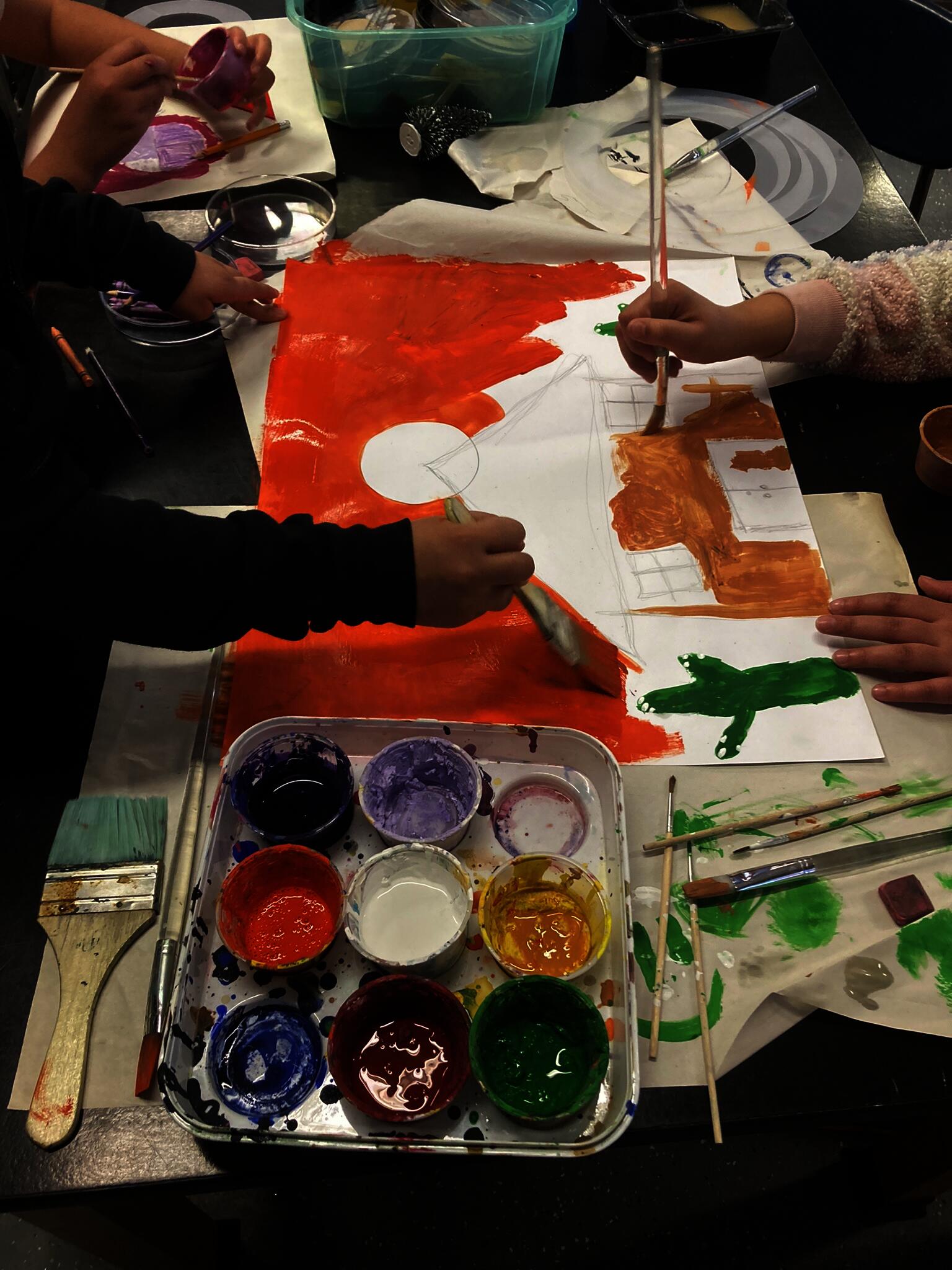 Fourth grade students work together to paint the setting for their stop motion movie
