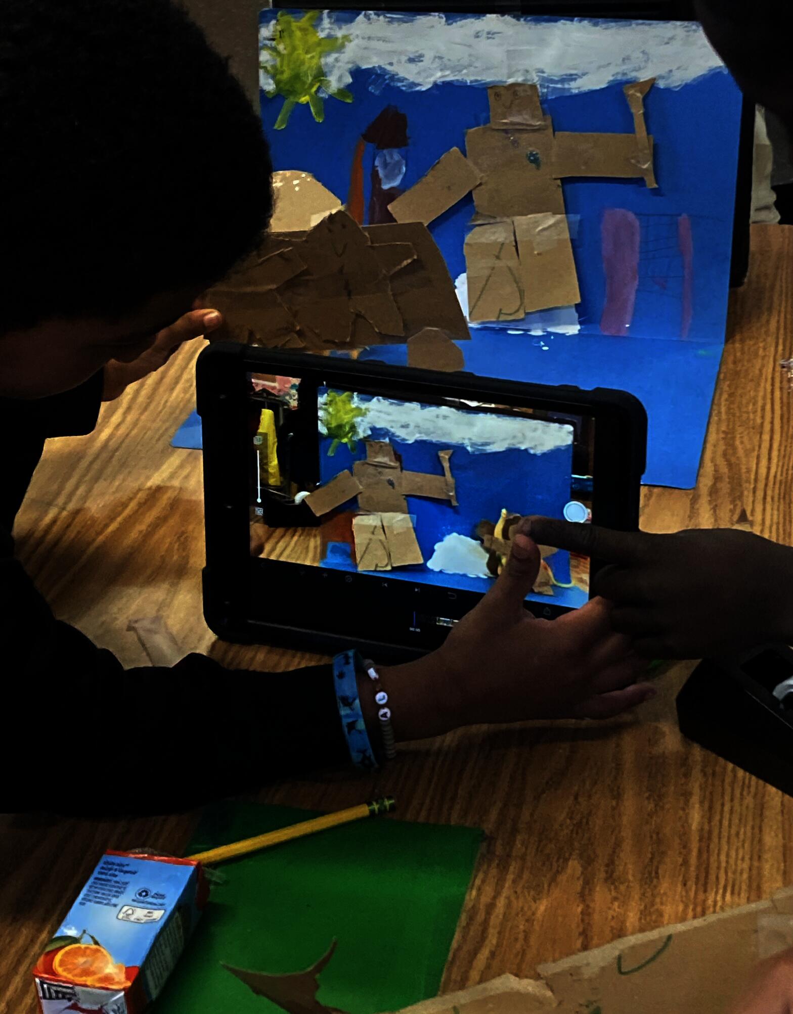 Two fourth grade students work together to film stop motion animation.