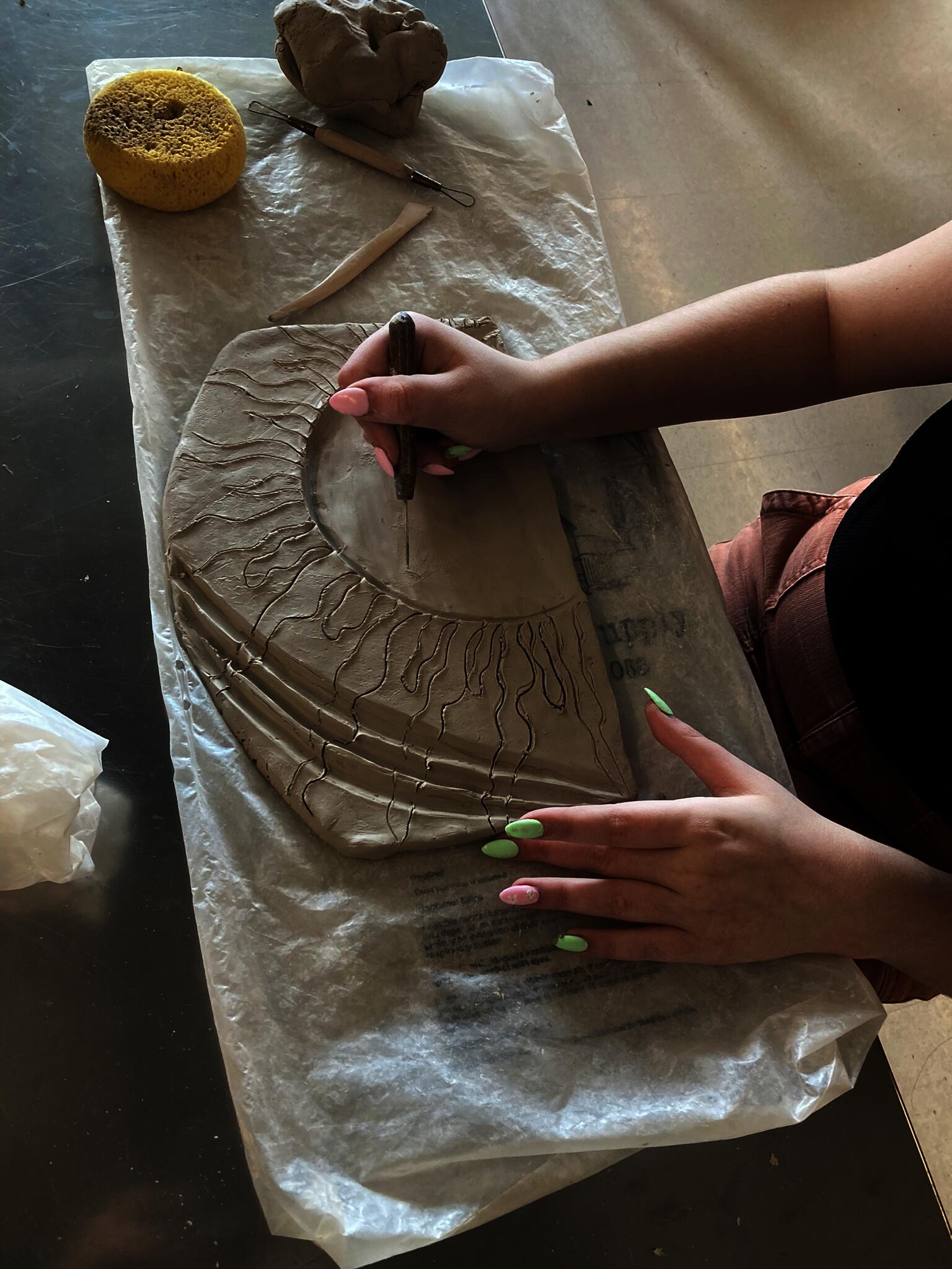 High school student handbuilds a ceramic mural piece