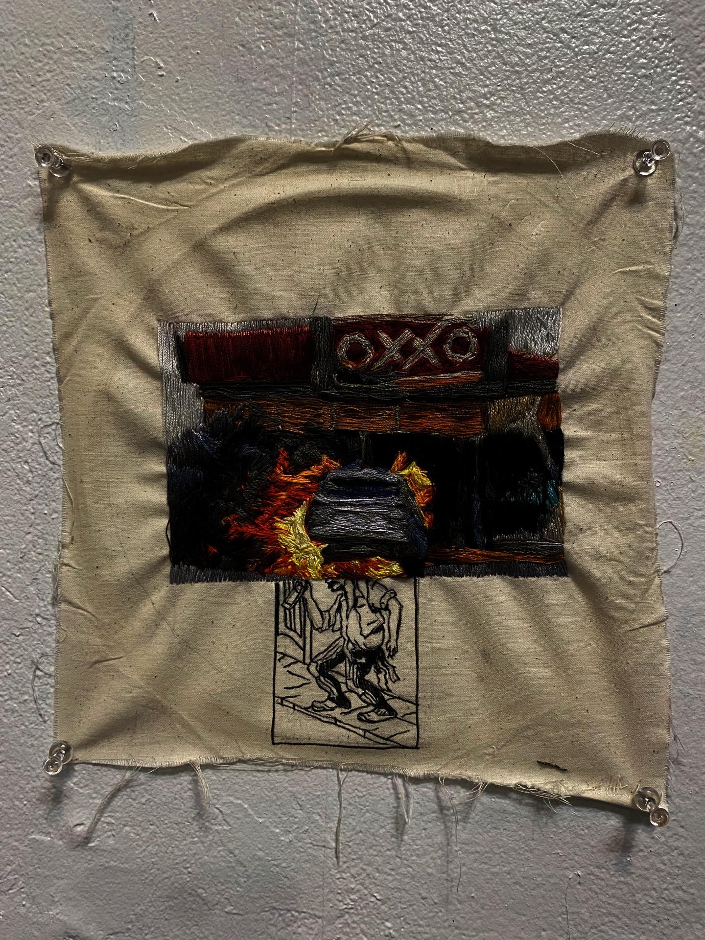 embroidered image of car on fire in front of convenience store