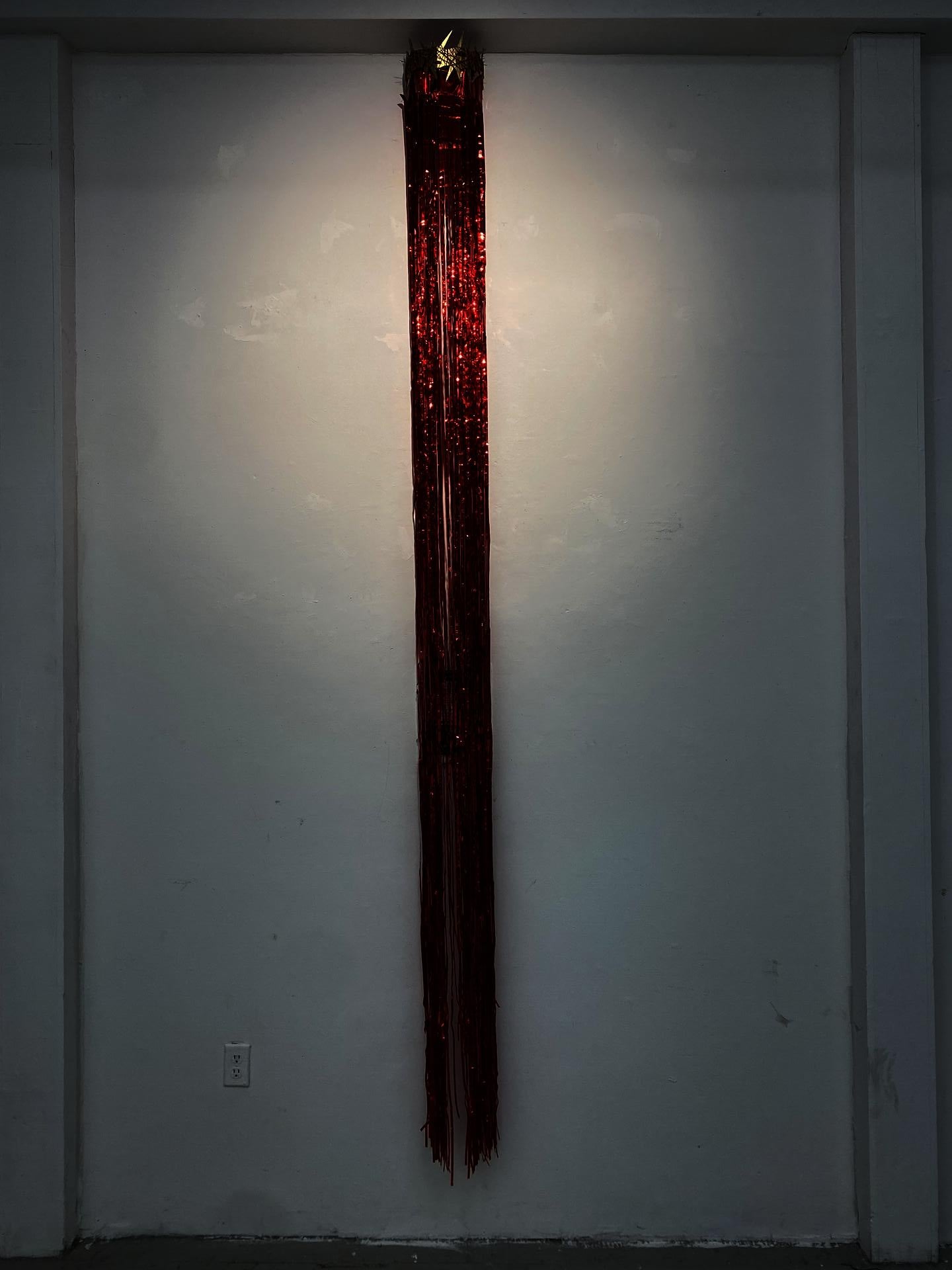 cardboard crown with red streamer hang off of it covering a document.