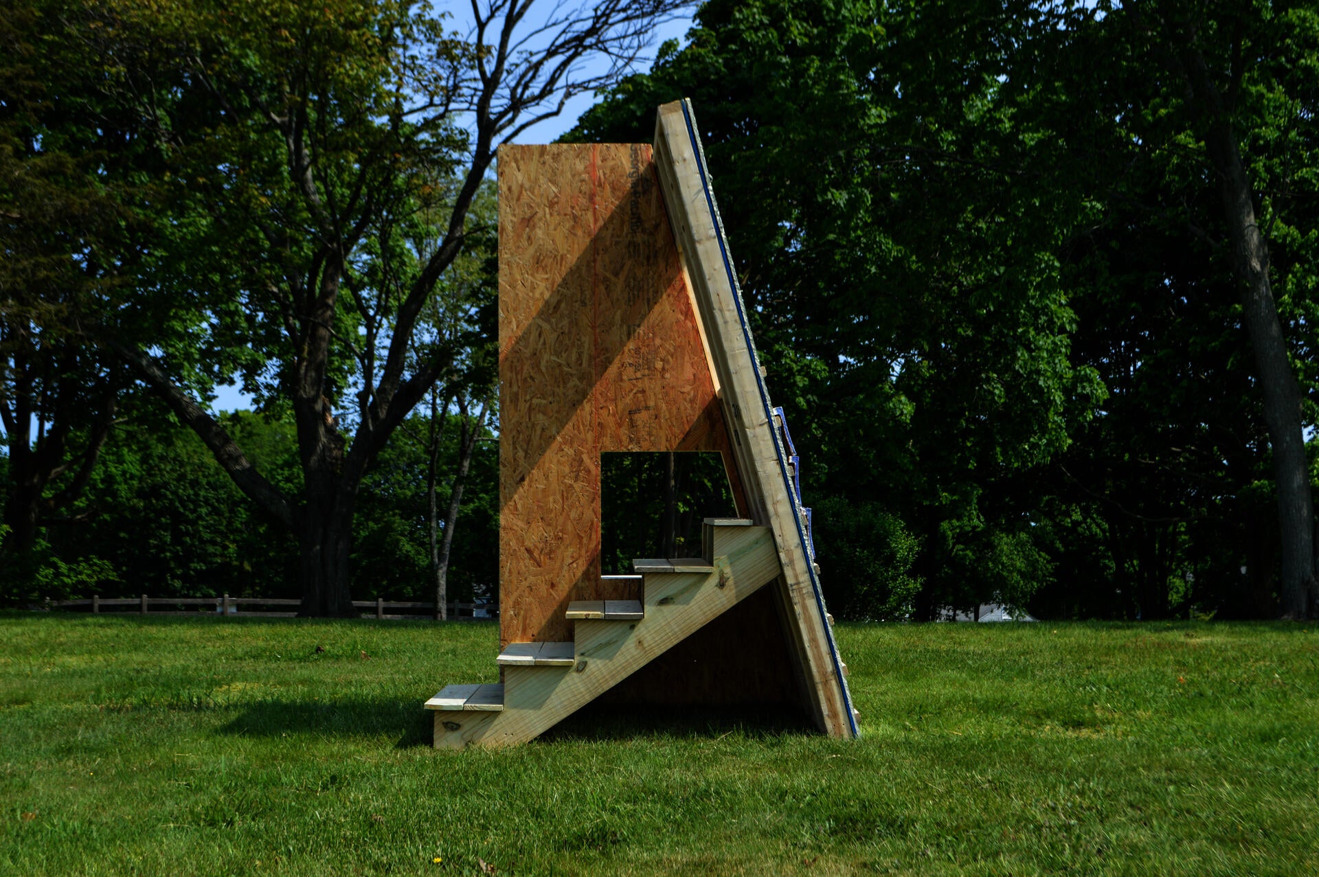 Sculpture in green field.