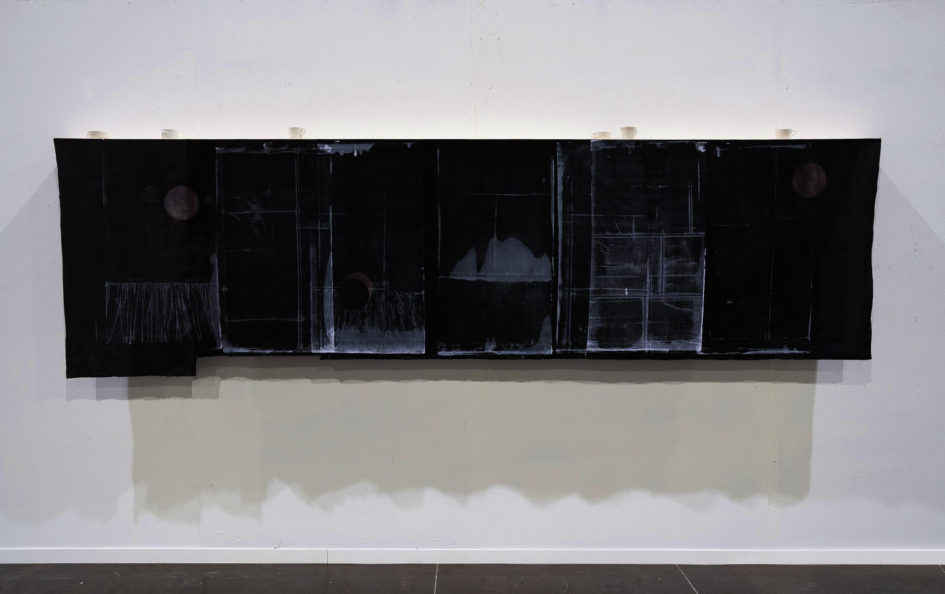 length of printed black fabric with faded windows and moons