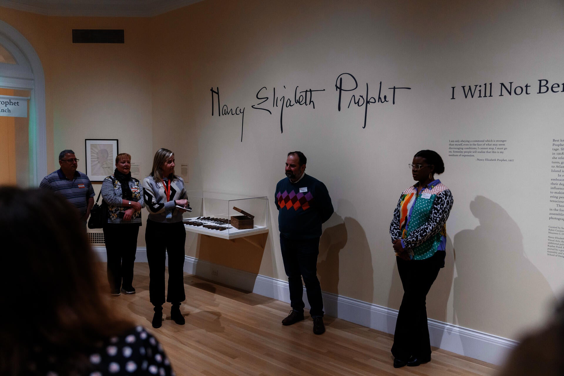 people standing in a gallery