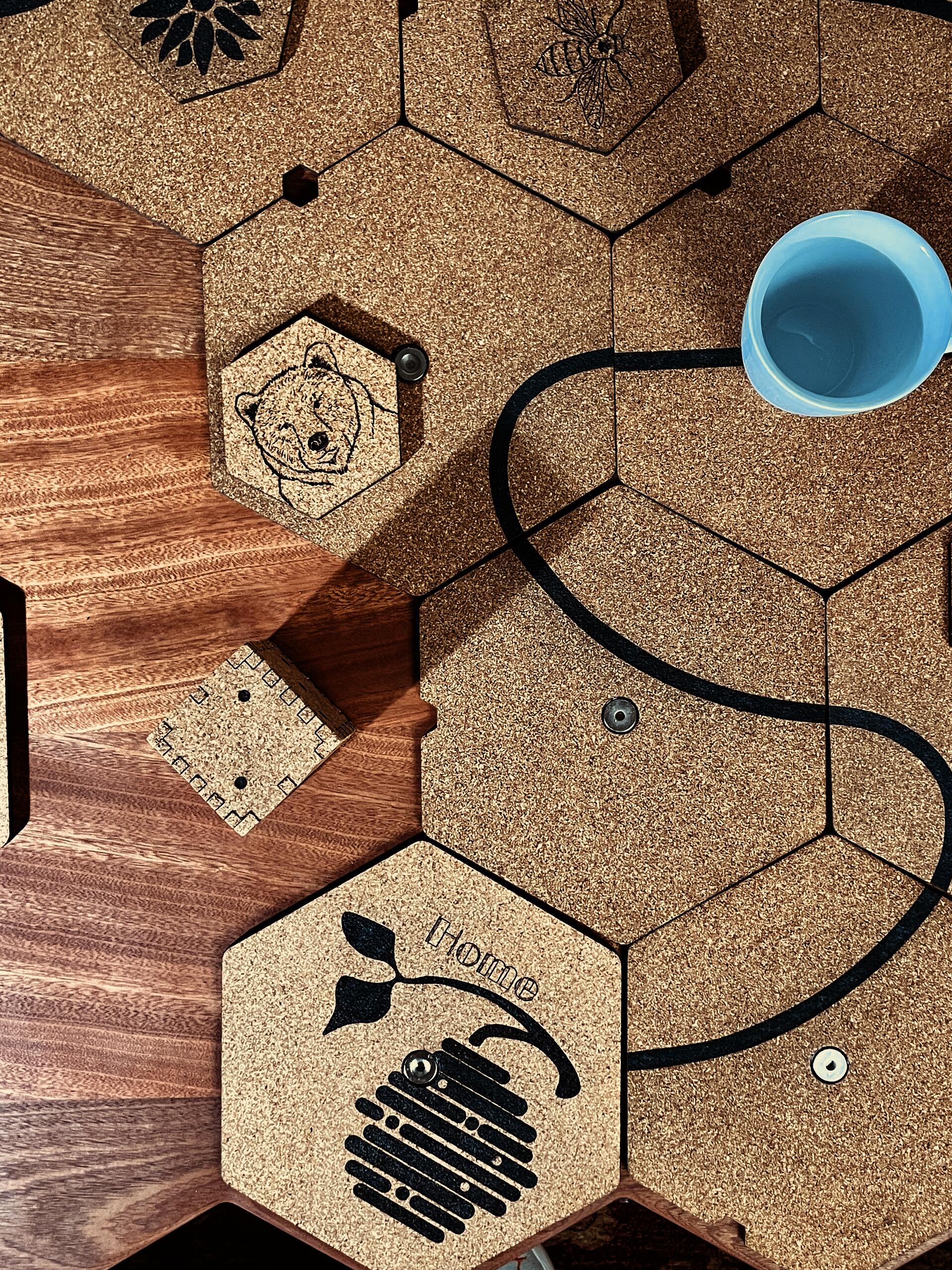 hexagon cork tiles used for game play, hexagonal cork coasters, bear coaster, bee coaster. White cup. Cork Home Tile, Sapele Wood, cork game die