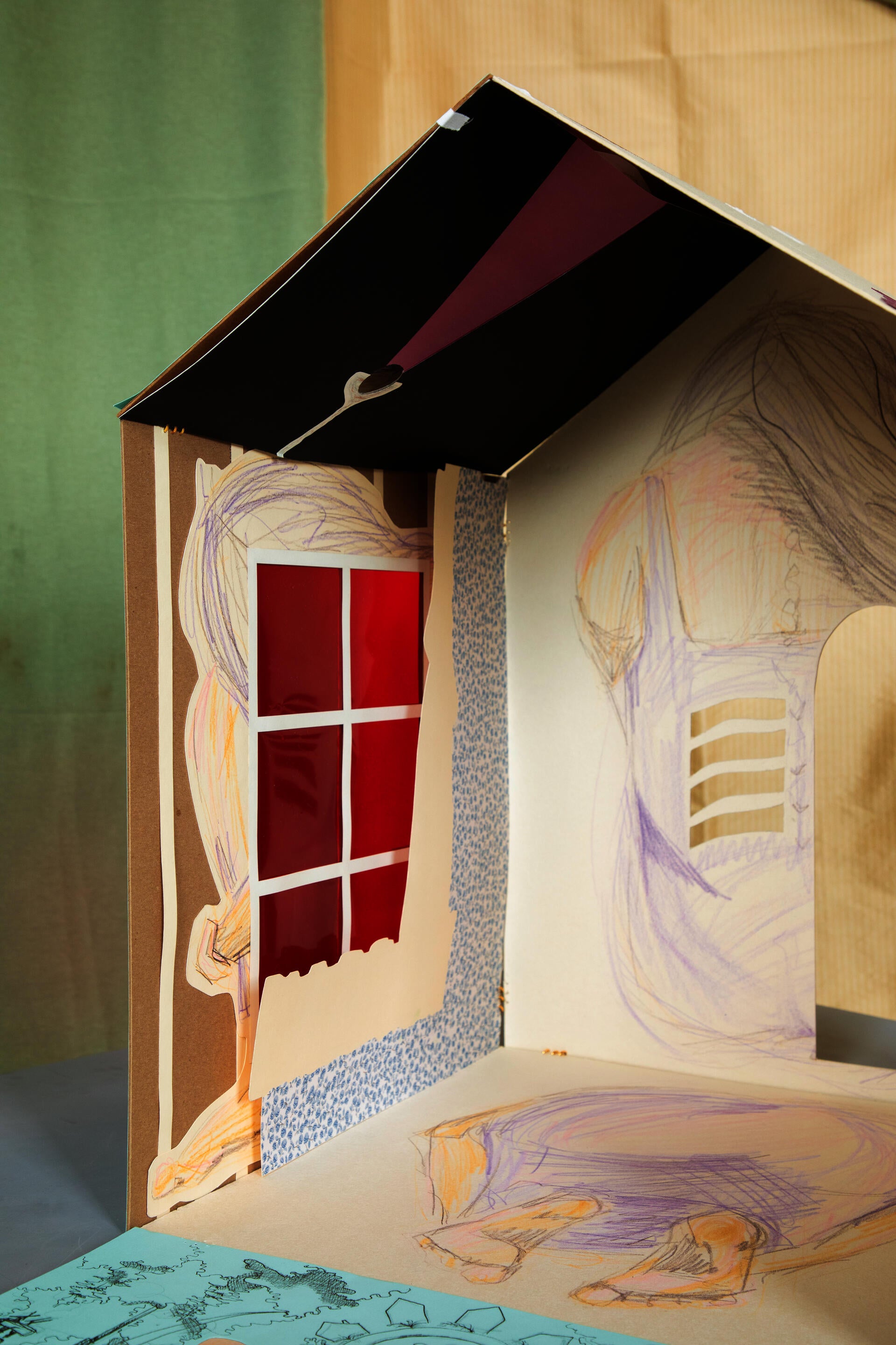 Interior view of house form with depictions of the human form drawing on the interior walls 
