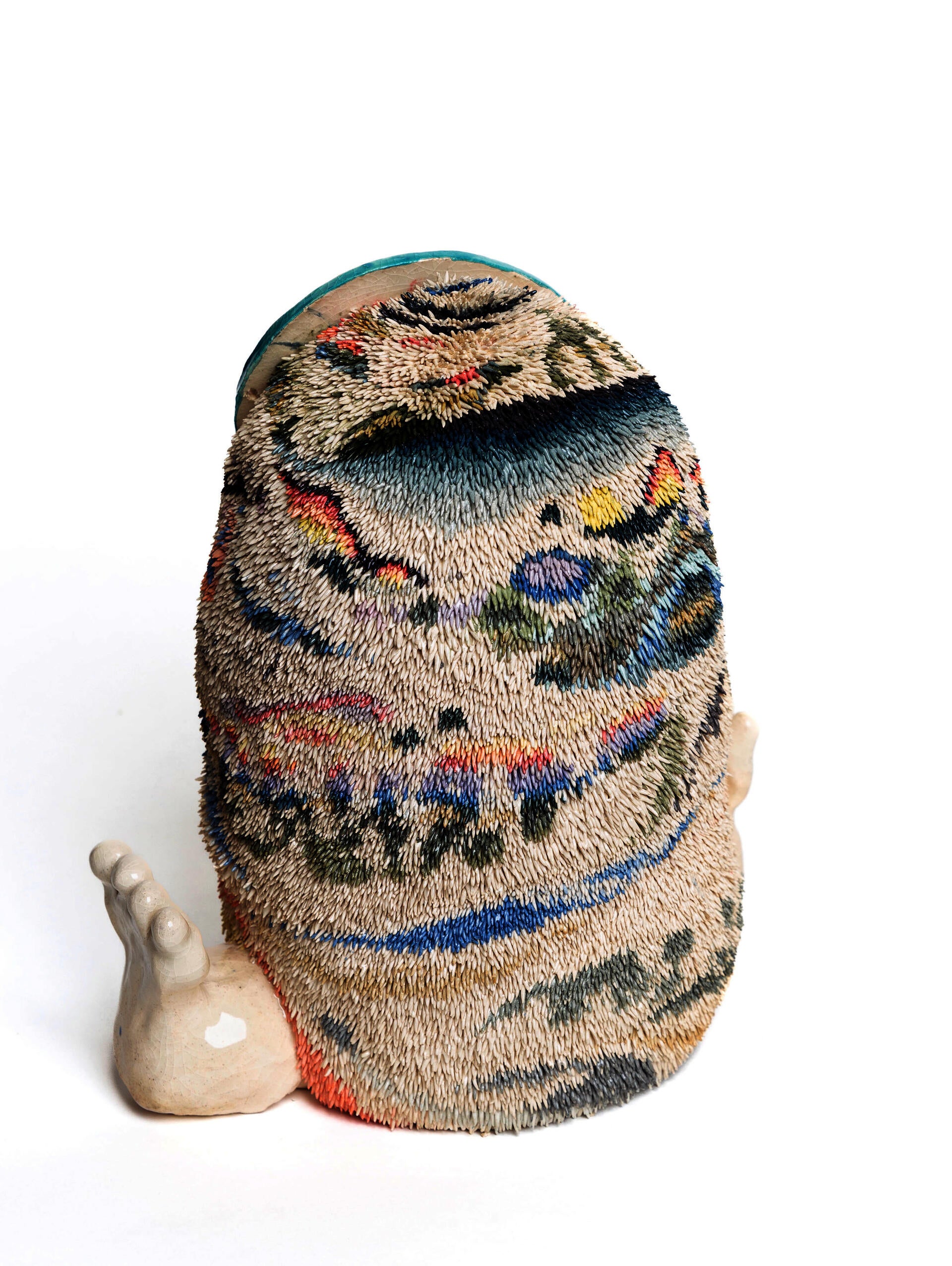This is an image of the back of a furry creature- the fur is made of stained clay, and therefore has colorful patterns.
