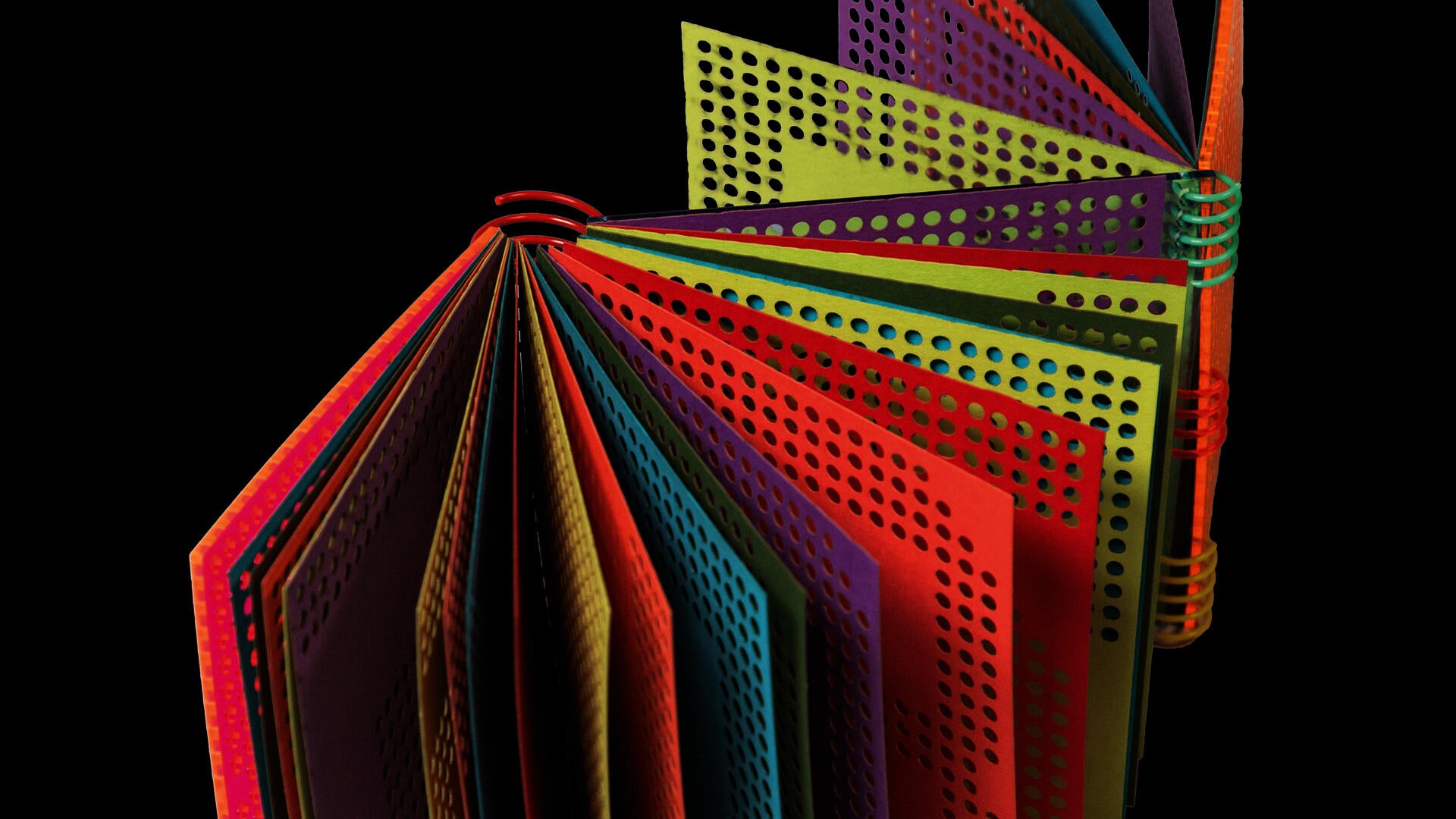 A book with a do-si-do binding and a coil binding. The pages are made of colored paper with holes punched in them to match the coil modulation.