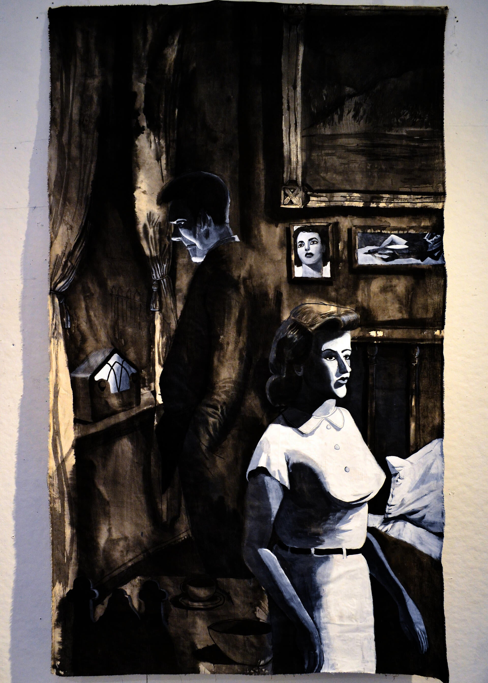 A rectangular black and white painting of two figures facing away from each other in a bedroom. 