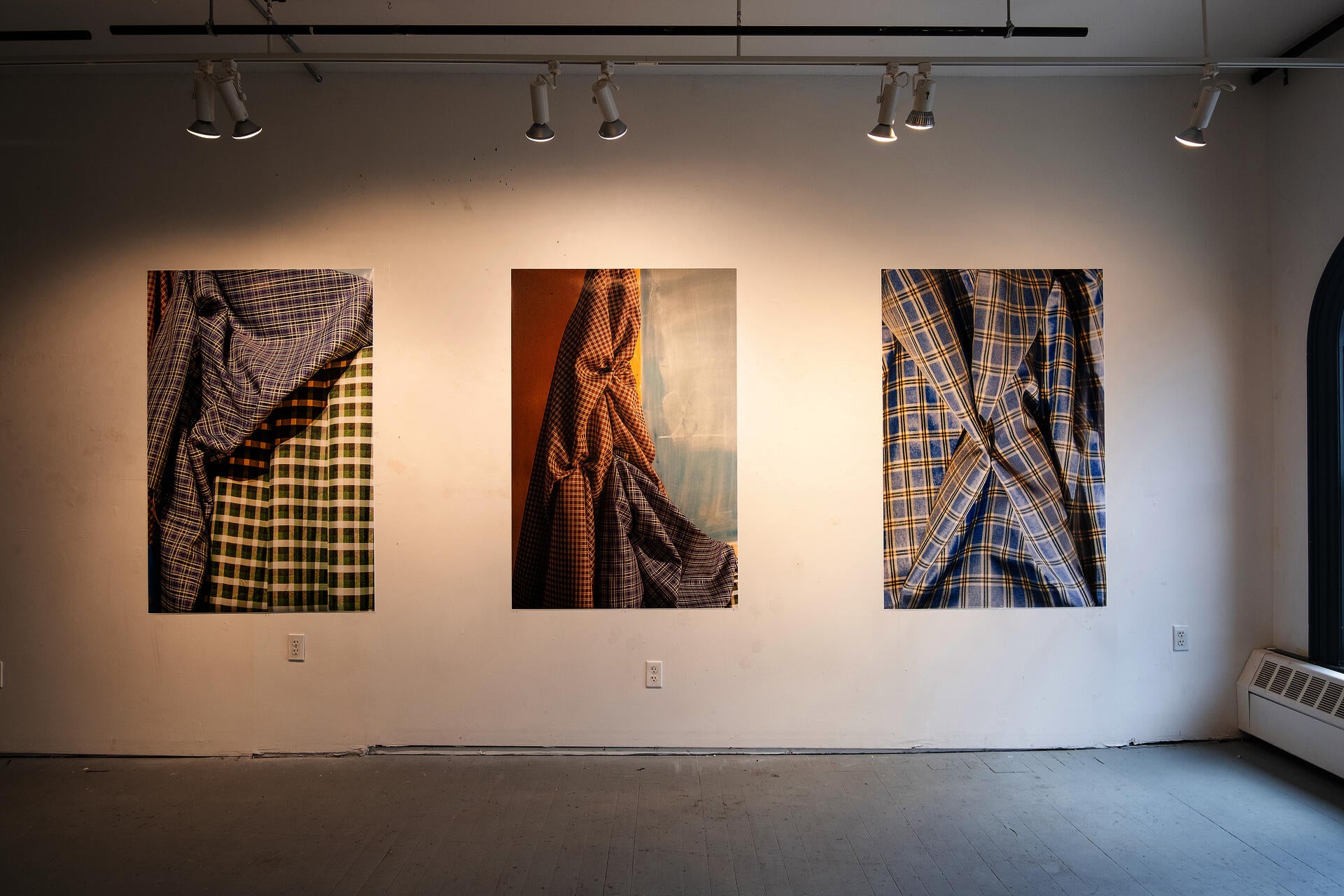 three works in a gallery