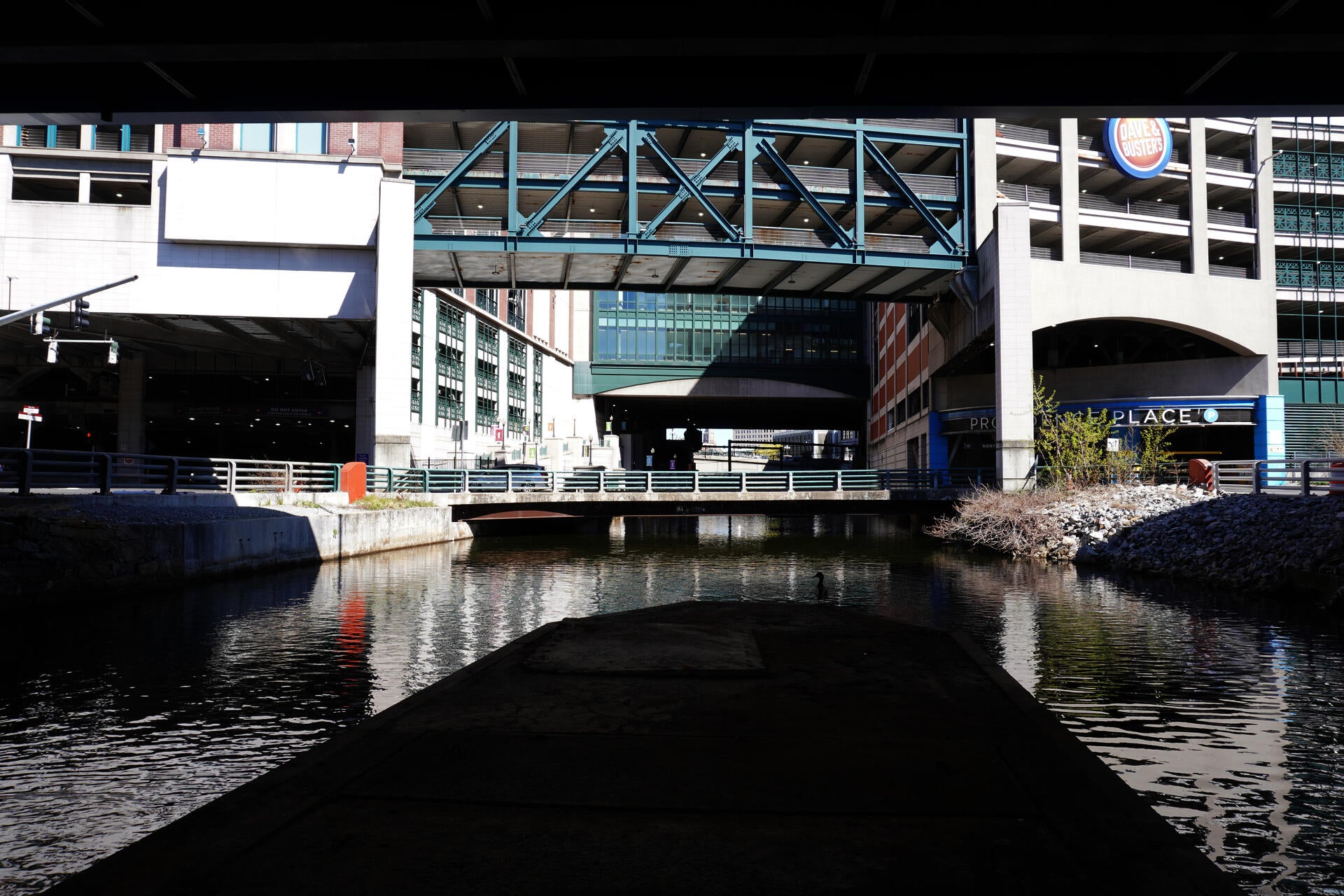 A photograph of the river running beneath the Providence Place mall under the structure above.