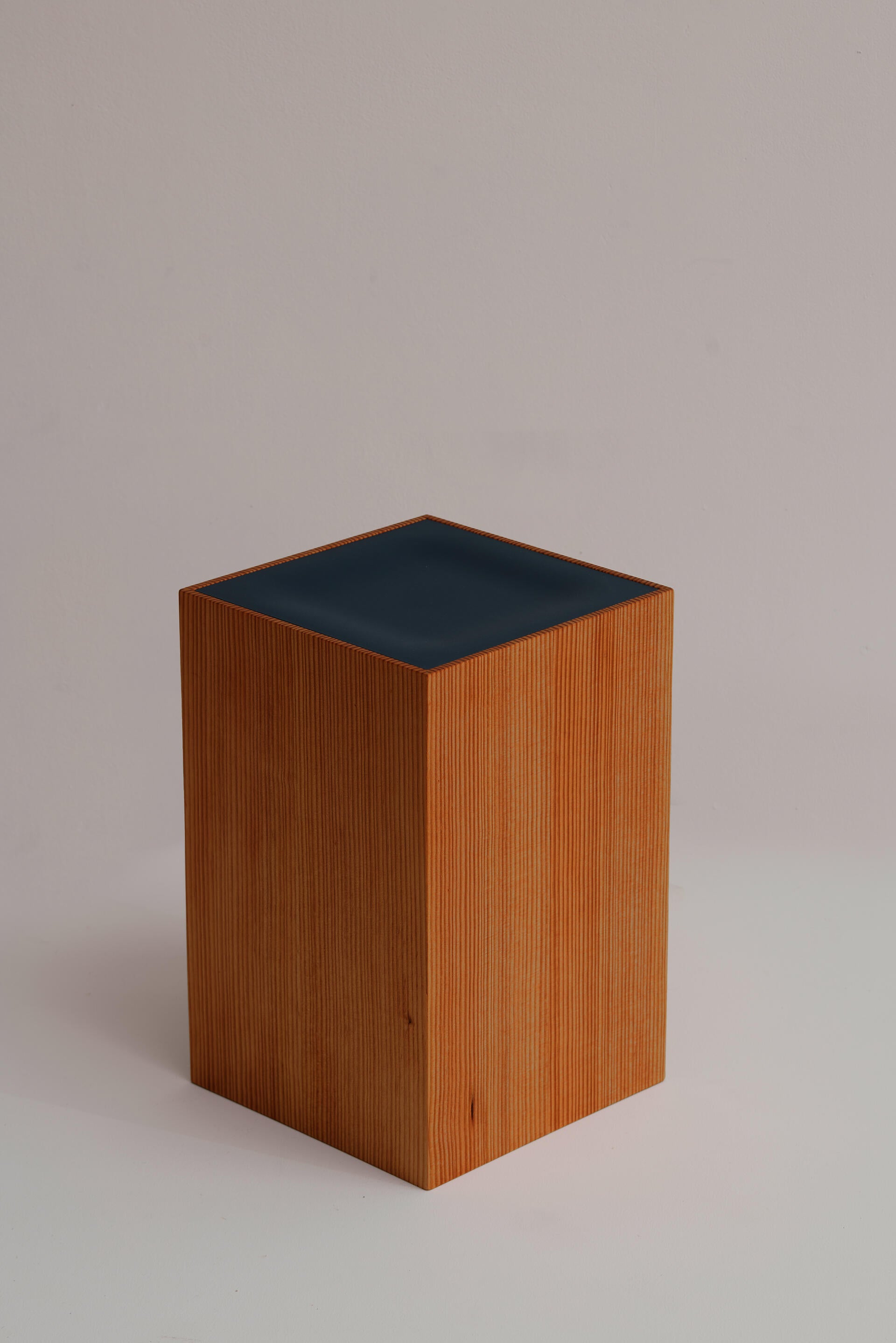 Box stool with subtle impression at center