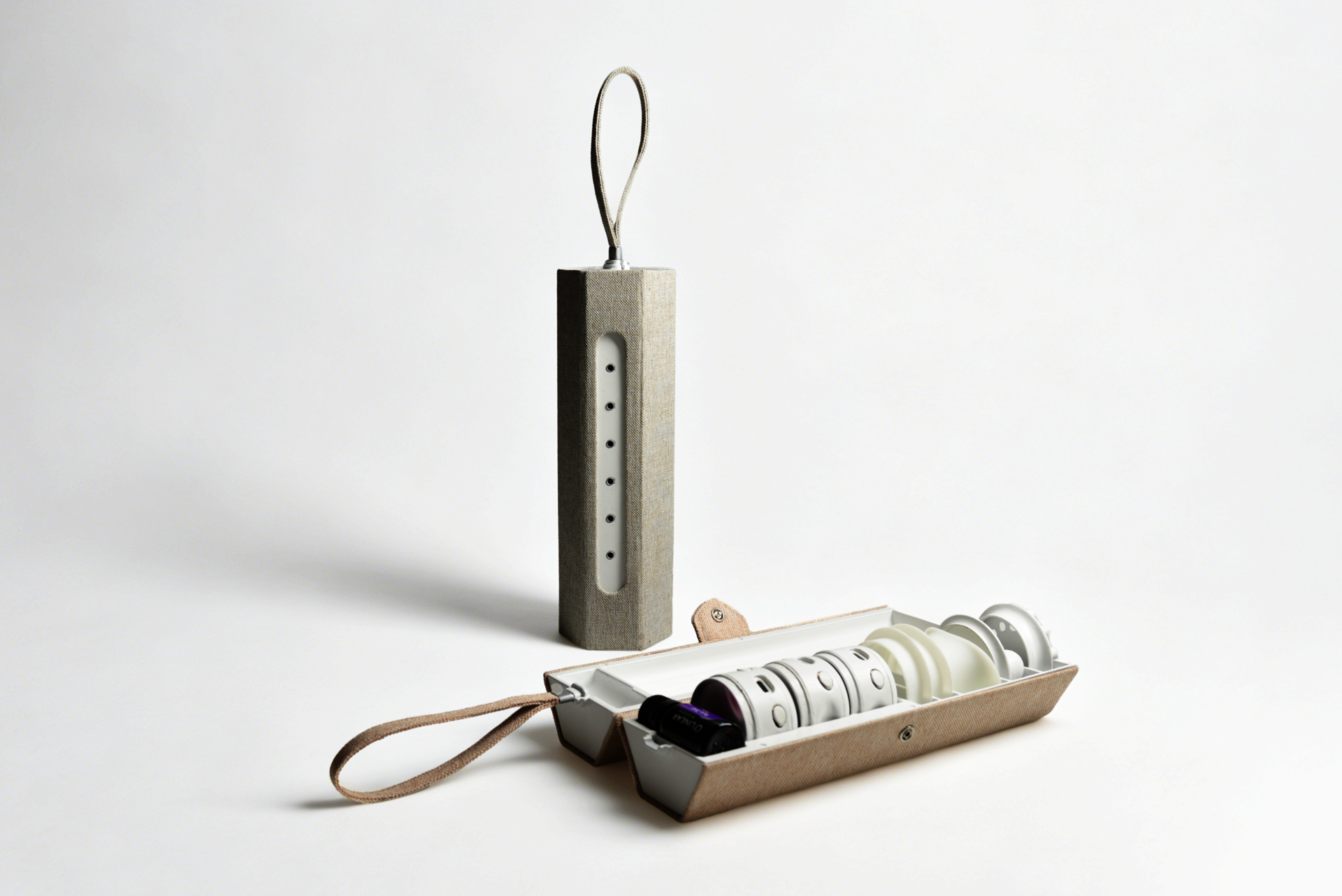 Two fabric-covered steam device cases in beige and gray; one open and laid flat revealing internal components, the other closed and upright.
