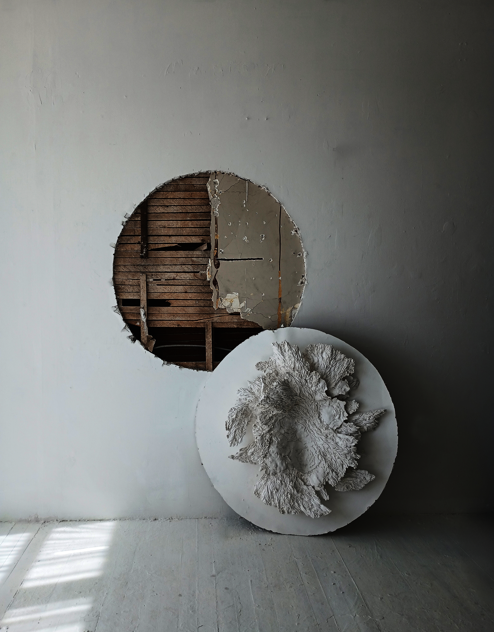a hole in the studio wall, the drywall used as base for plaster textural form