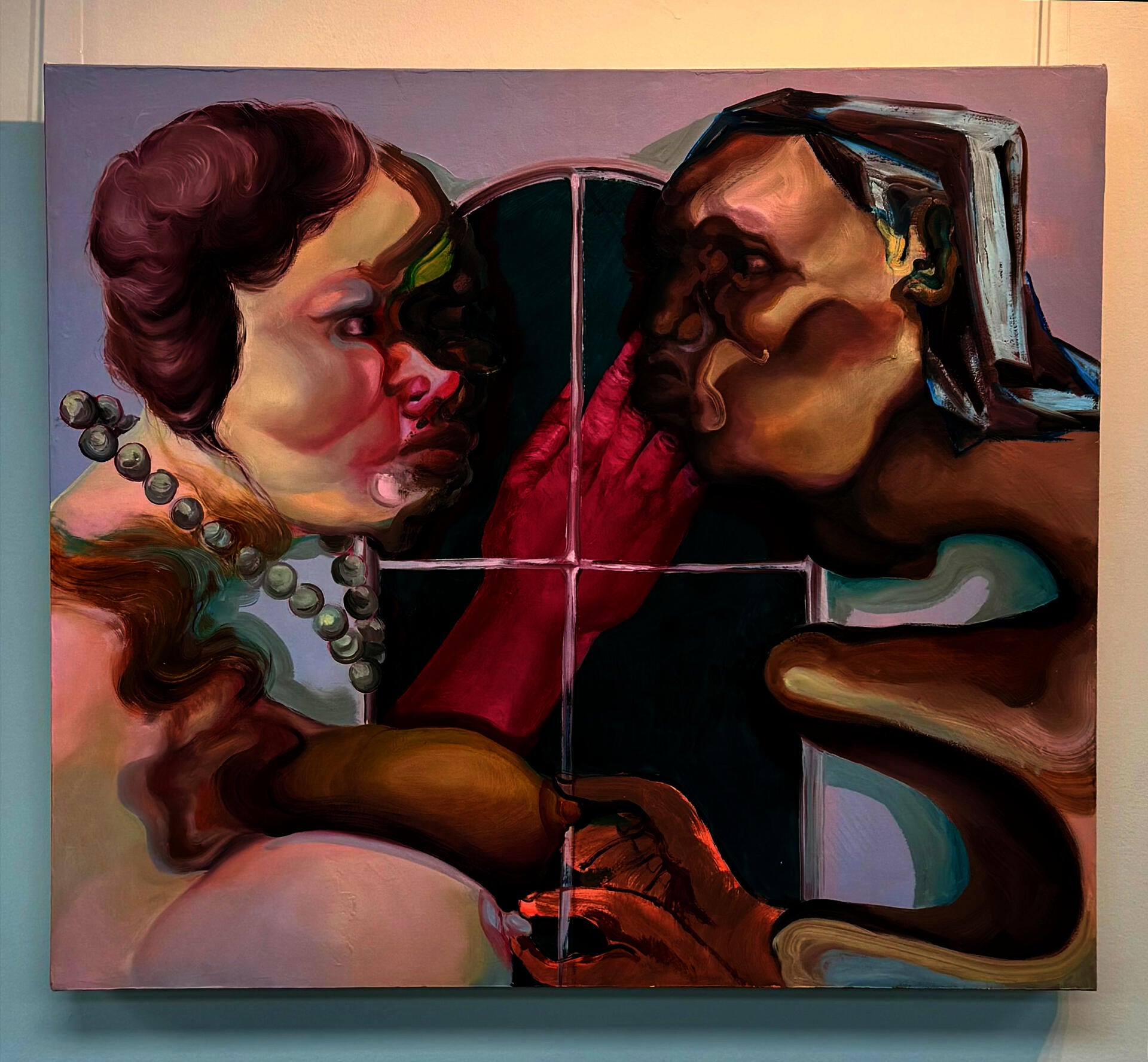 Two figures facing one another in front of a pastel purple window. A red praying hand is behind them. 