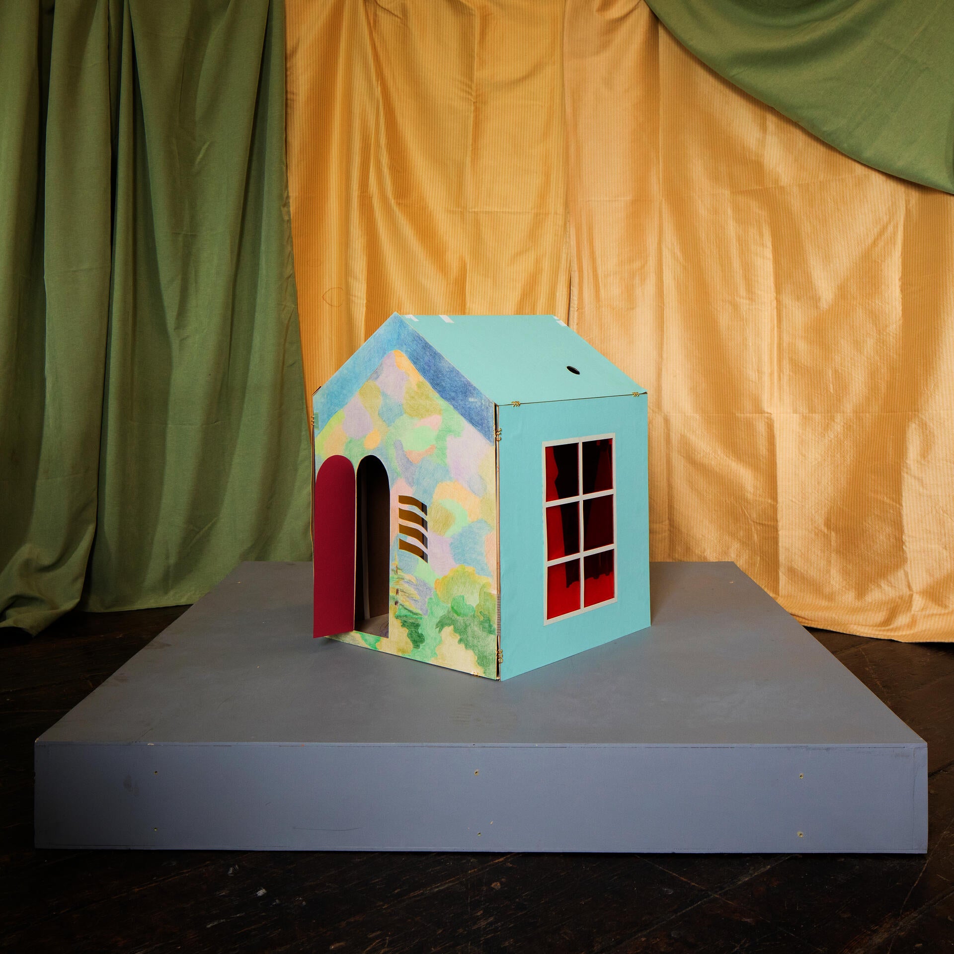 a house form with drawings of the environment as its covering. 