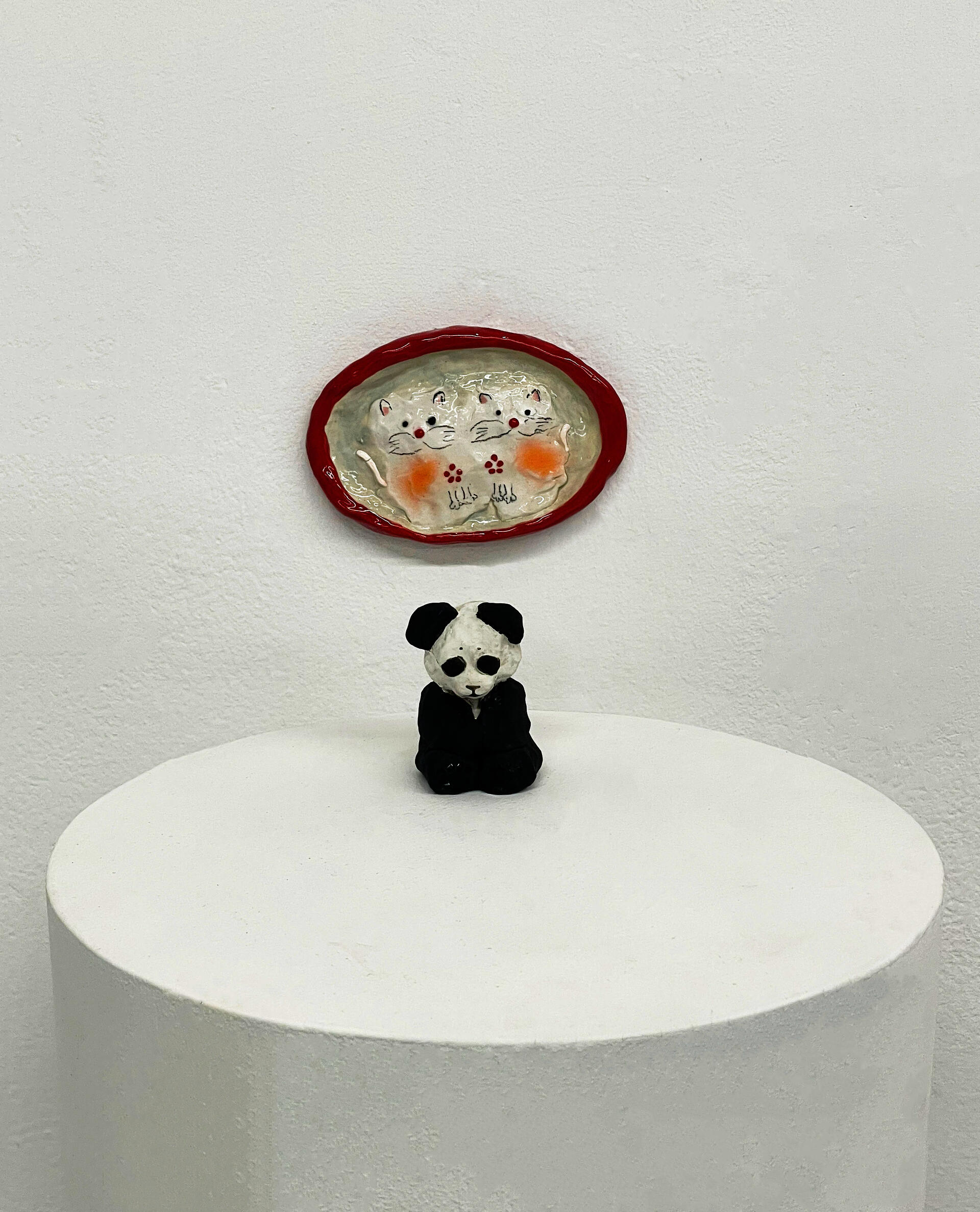 Small ceramic figure combining a panda and cat with fuzzy texture. Playful hybrid form referencing 1980s Chinese imagery and nostalgia.