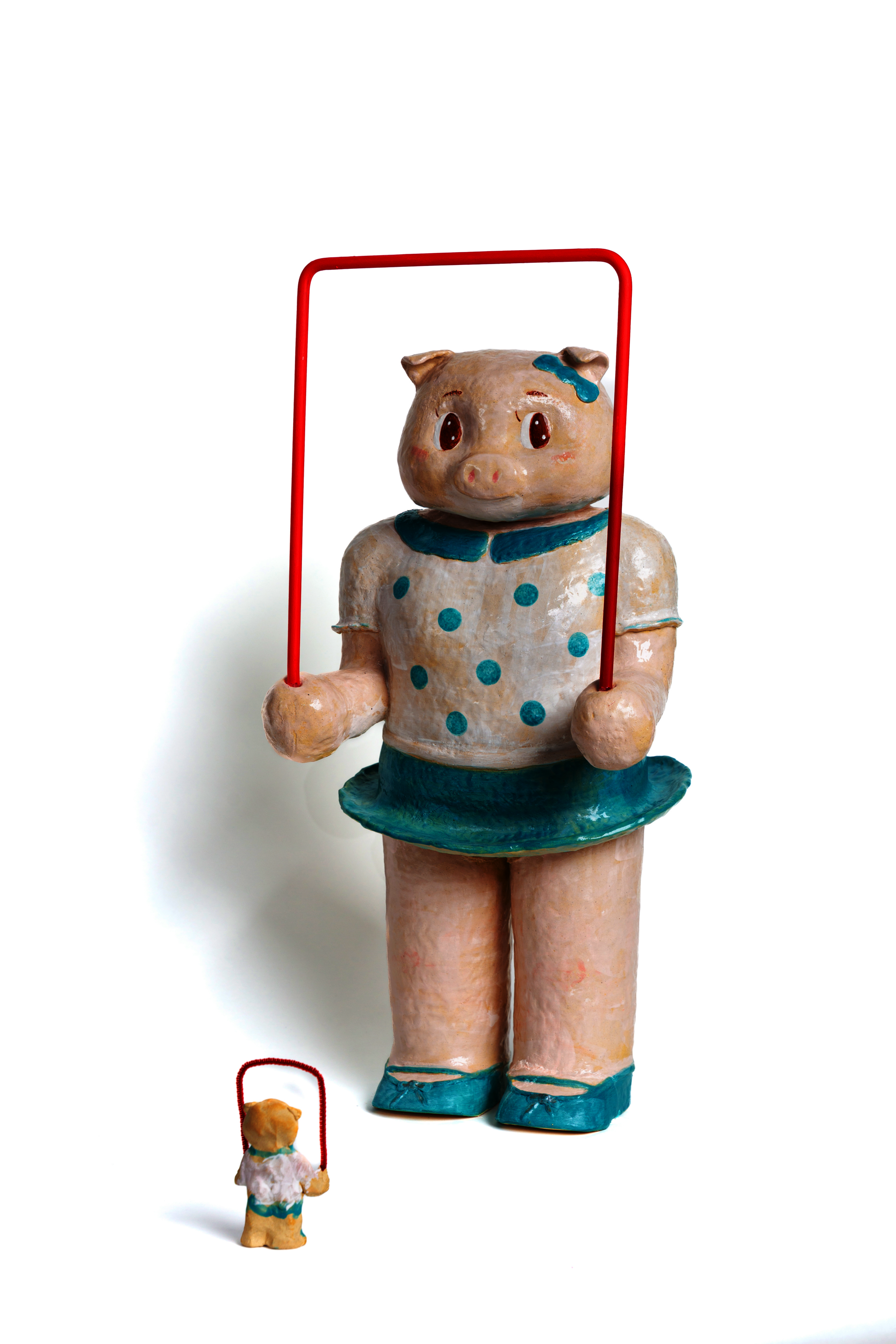 Enlarged jumping rope pig toy. Playful form referencing childhood toy and early cultural exchange.
