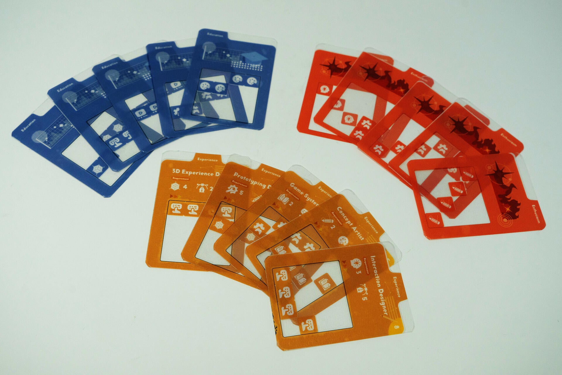 Colorful tabletop card game prototype displaying transparent overlays, modular experience cards, and role cards used for resume-building, storytelling, and persuasive communication gameplay.