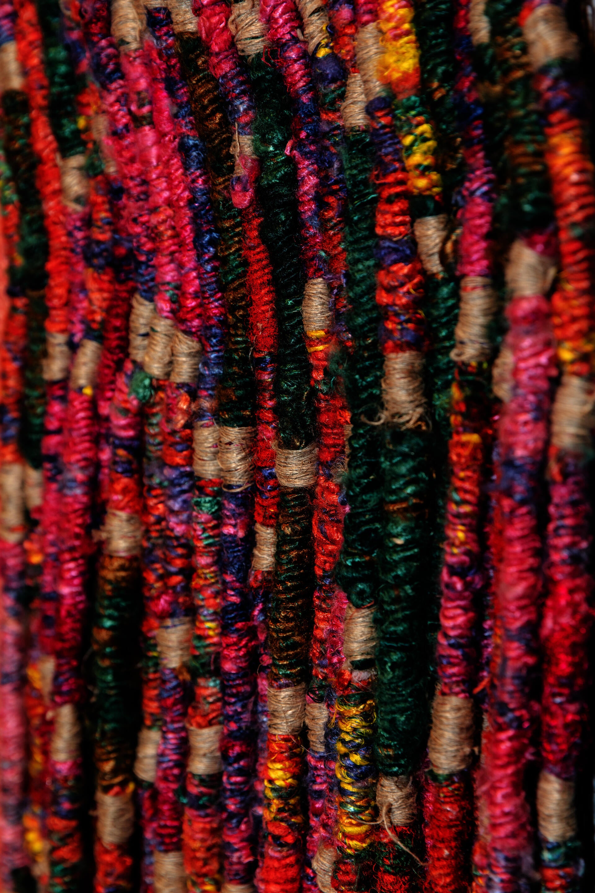 Multi-color recycled saree yarn hand twisted to create a material surface with modular assembly. Title: Parts in circulation