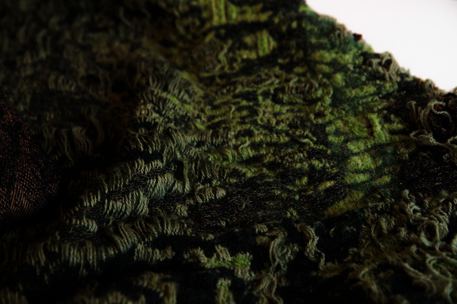 Jacquard woven and hand felted fabric designed and engineered to simulate wild grass as a rug.