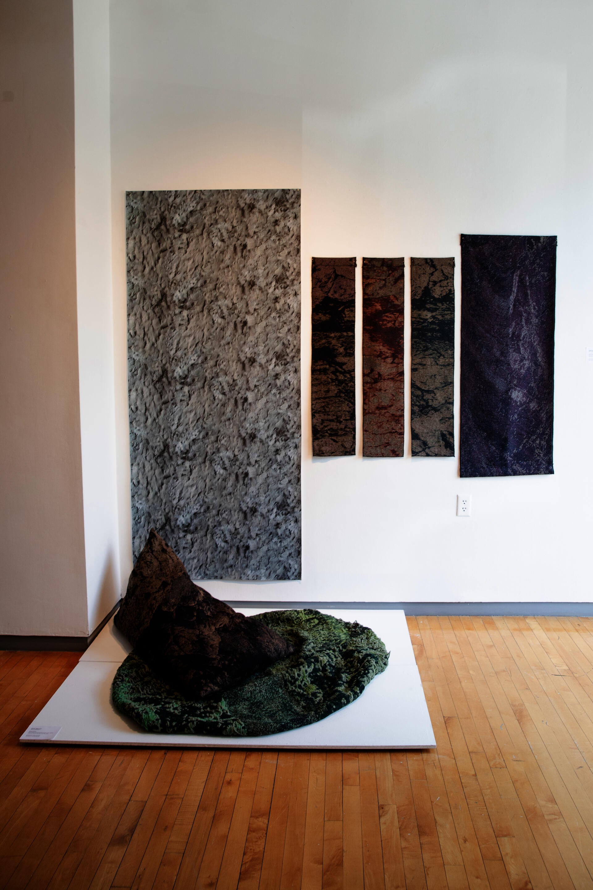 Jacquard woven textiles designed and engineered to simulate different types of rock surfaces. Rock shaped bean bag and fabric lengths. 