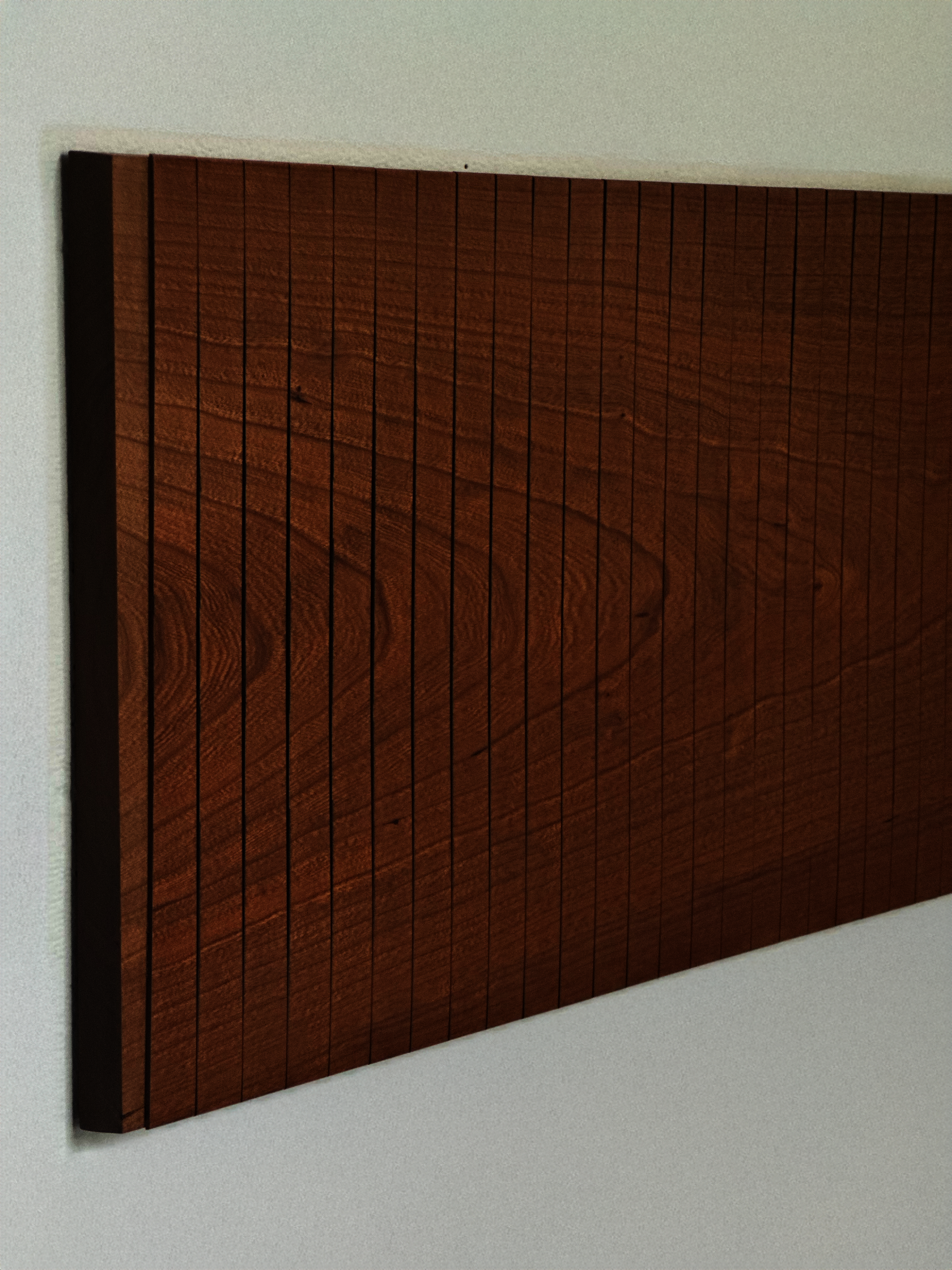 Rectangular cherry wall panel composed of evenly spaced vertical strips with continuous grain patterns across the surface.