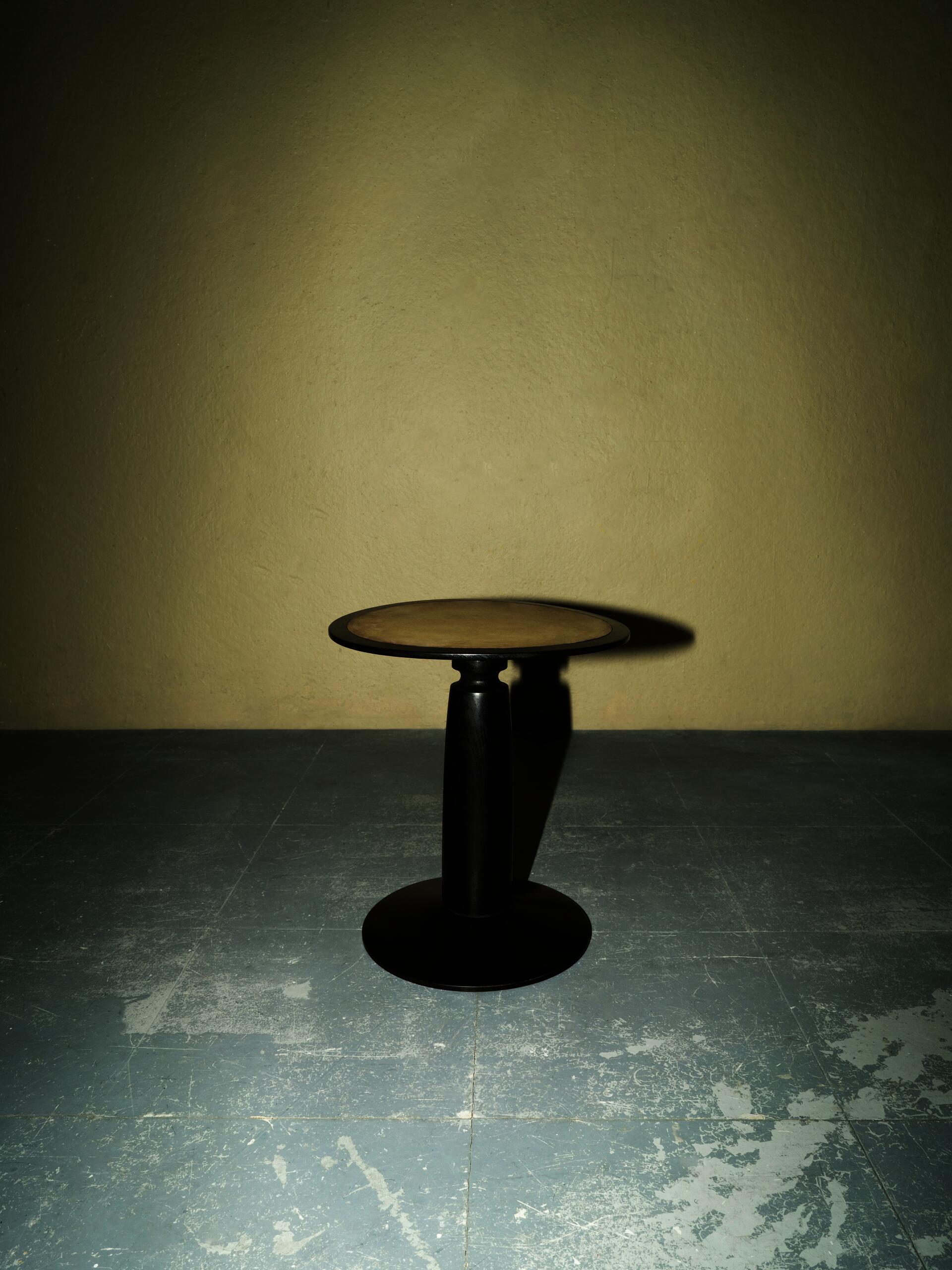 A stool with a moon shaped seat. 