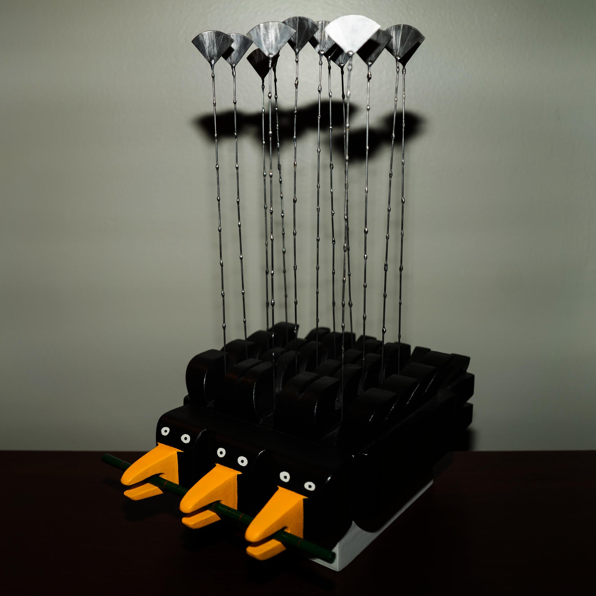 Instrument inspired by crows in Providence. Percussion instrument that produces sound by brushing the steel elements with the hand or a stick.