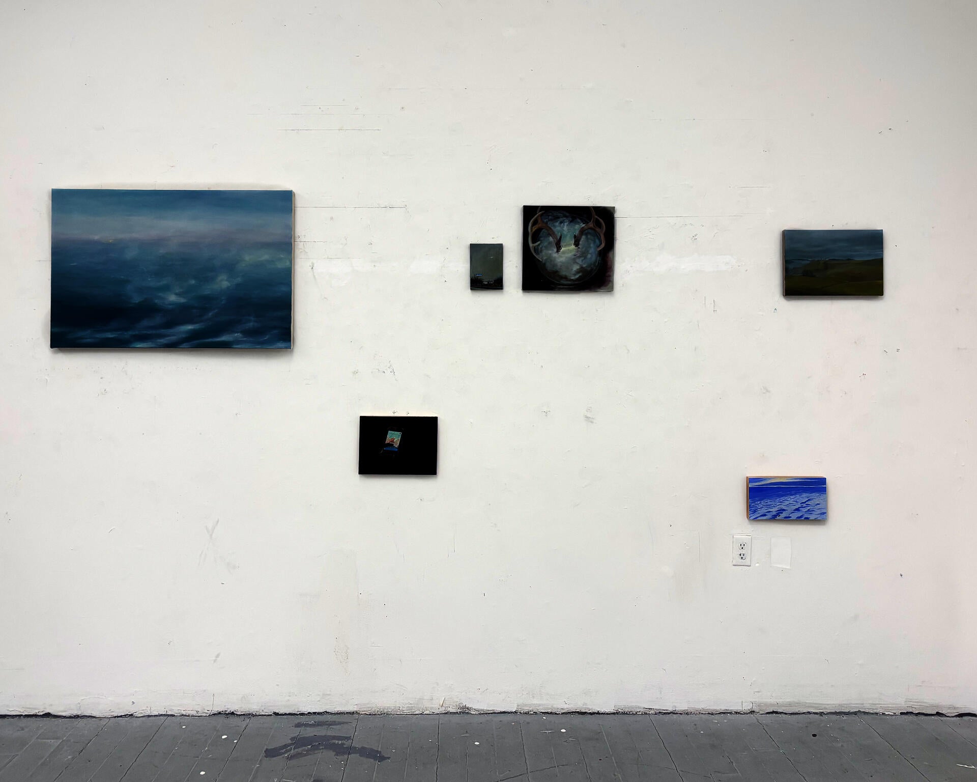 This is an installation shot of a group of 6 paintings, hung at varying heights. 