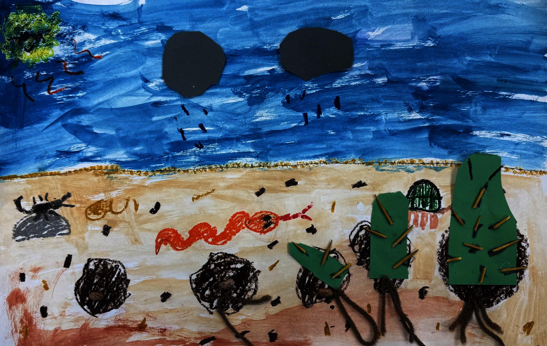 This is a painted/ collaged diagram of the germination cycle of a cactus. It is made of construction paper, toothpicks for the cactus spikes and kidney beans for the seed and yarn for the roots.