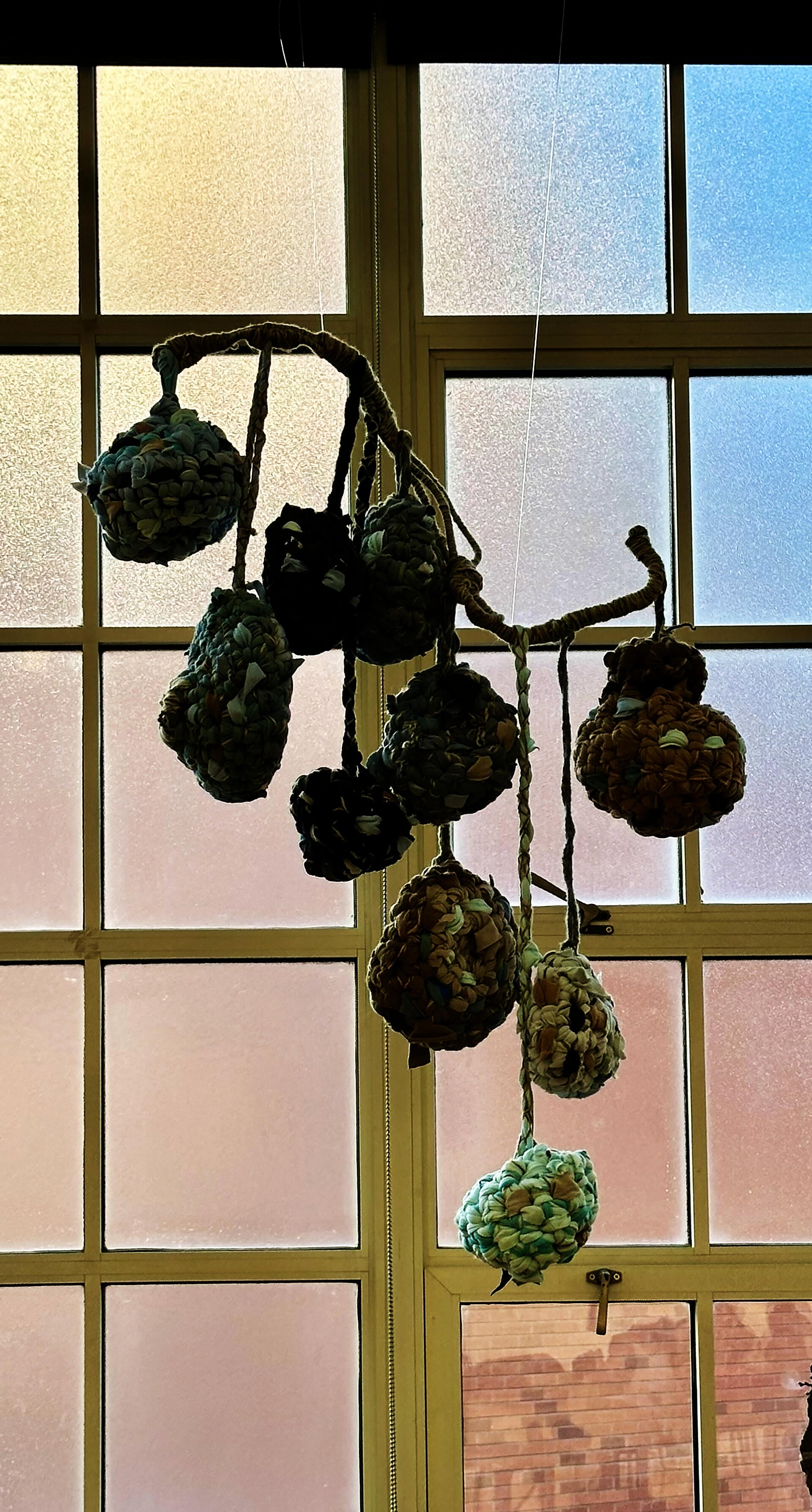 Rest is inspired by weaver bird nest and made with reused materials. Viewers are invited to collaborate with me by putting fabric and yarn scraps inside instead of sending them to the landfill. 