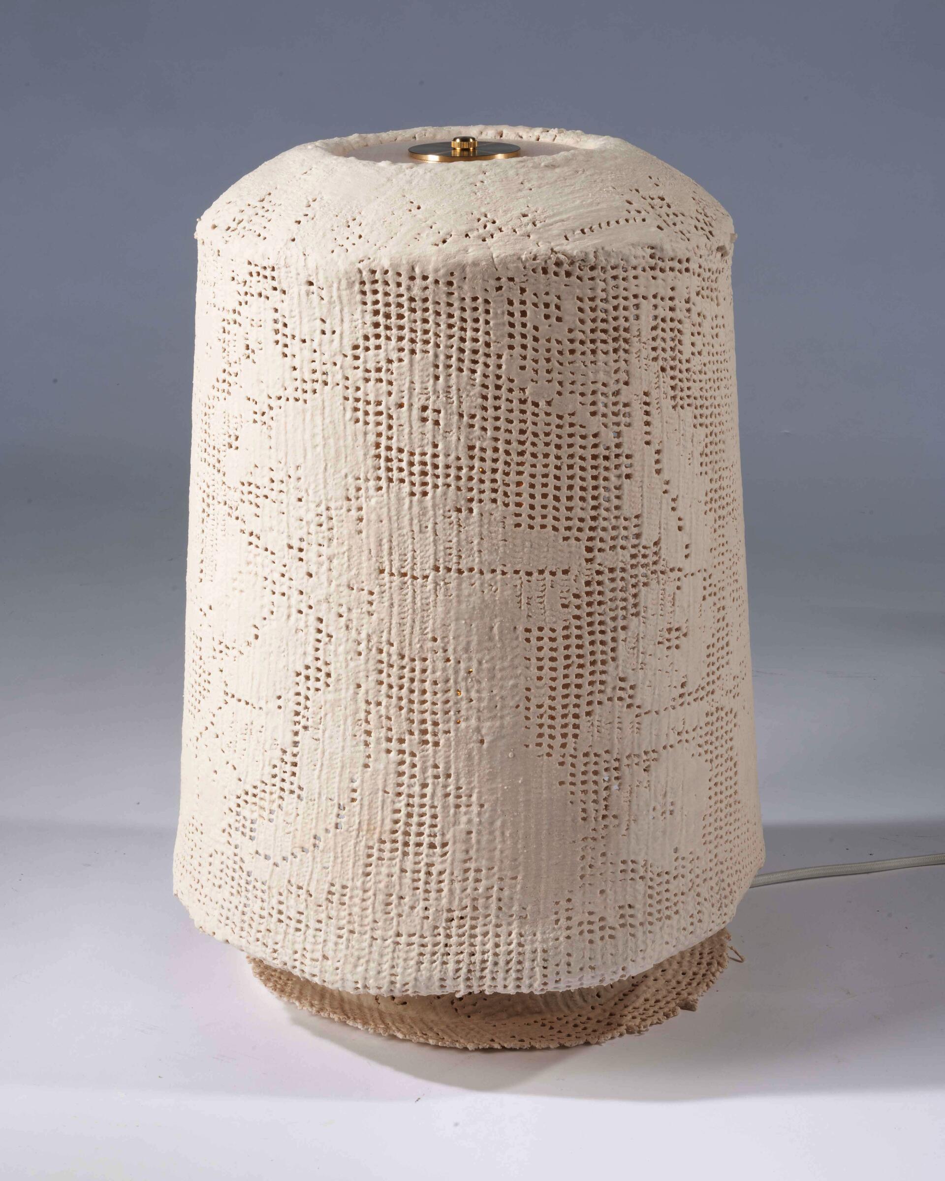 Filet crochet hardened into a table lamp. 