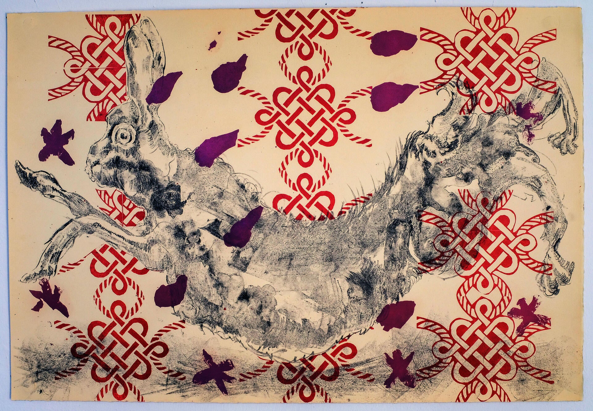 Jumping rabbit against a pattern of red knots and purple flower petals.