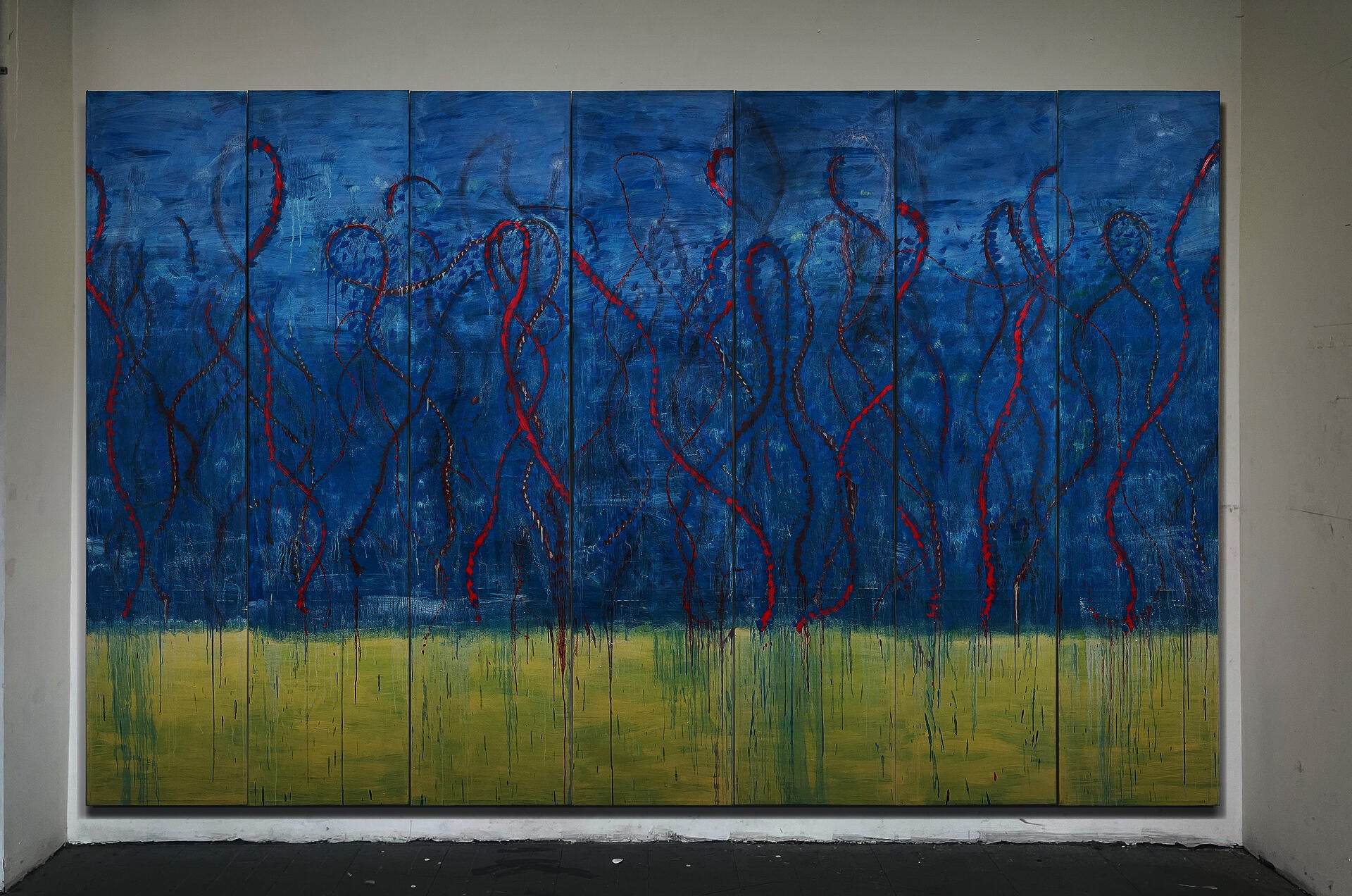 Large seven-panel abstract painting with an atmospheric blue upper field and pale yellow lower band, crossed by red and brown looping lines, drips, and visible seams.