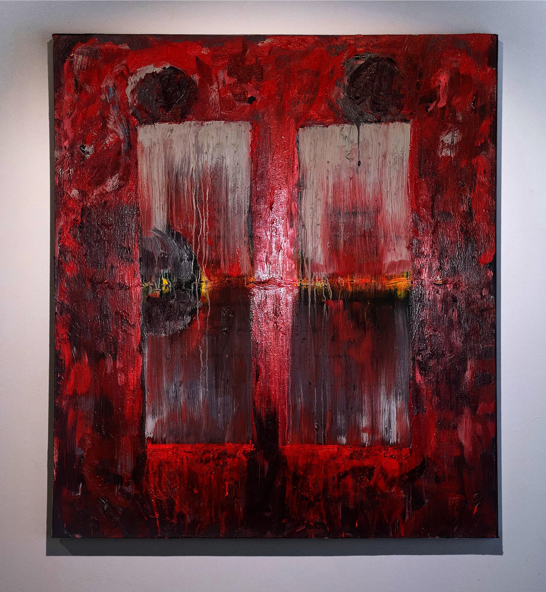 Red abstract painting with two pale vertical window-like forms, gray circular shapes, a thin yellow horizontal glow, heavy texture, and paint drips across the surface.