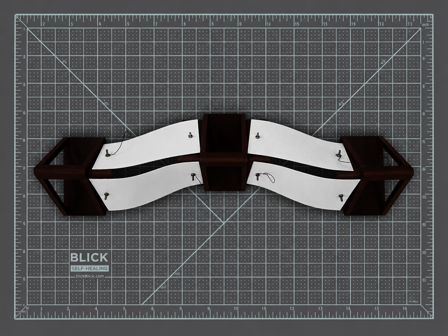 An assembly of three triangular cylindrical components with embedded Nitinol wire, forming the segmented body of Vermis to enable sequential contraction and directional crawling movement.