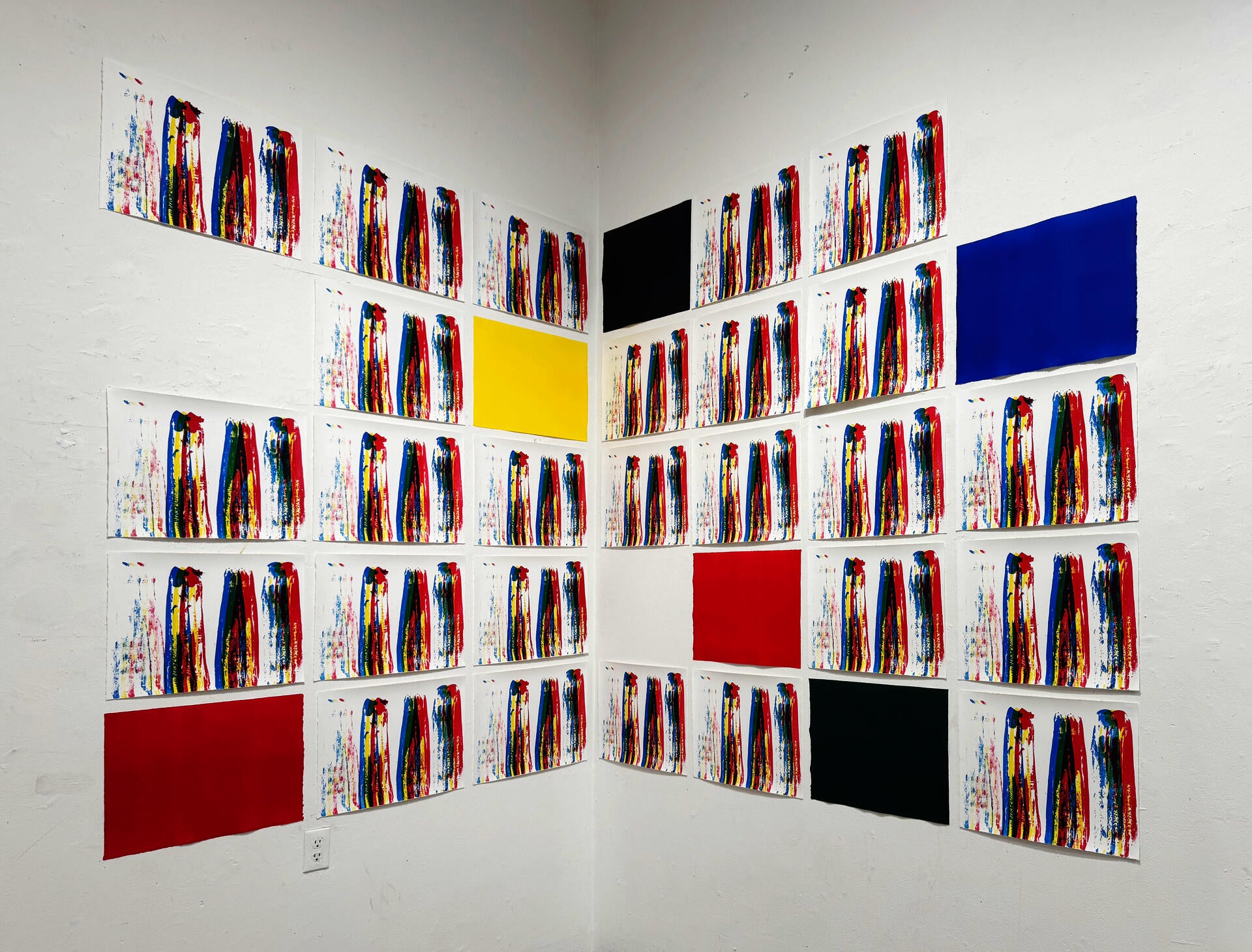 its an installation of prints, in the corner of the room, placed in a grid on each wall.