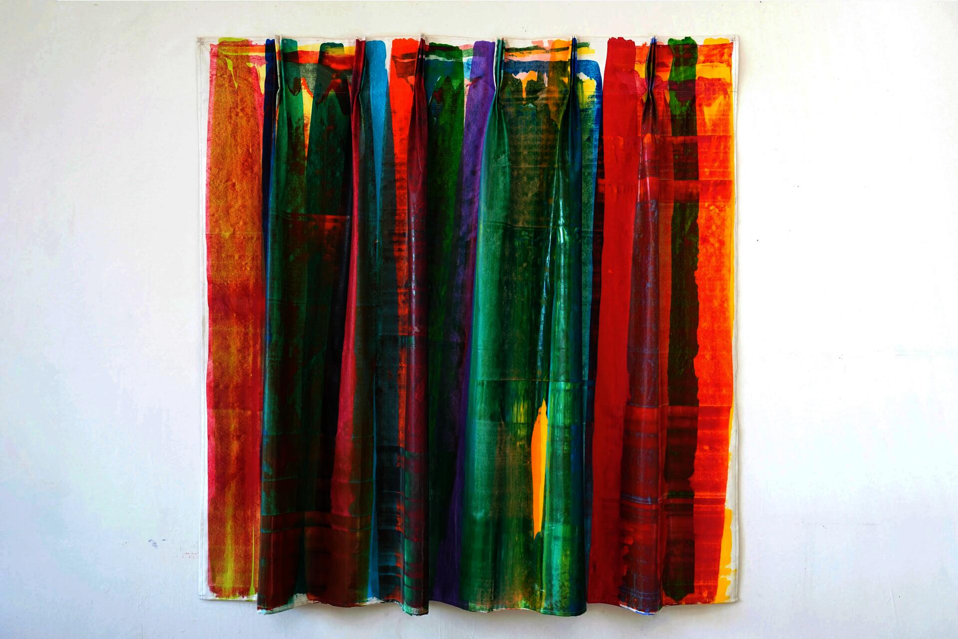 This artwork is a stitched canvas in a curtain format. shows multicolor streaks, layered on top of each other.