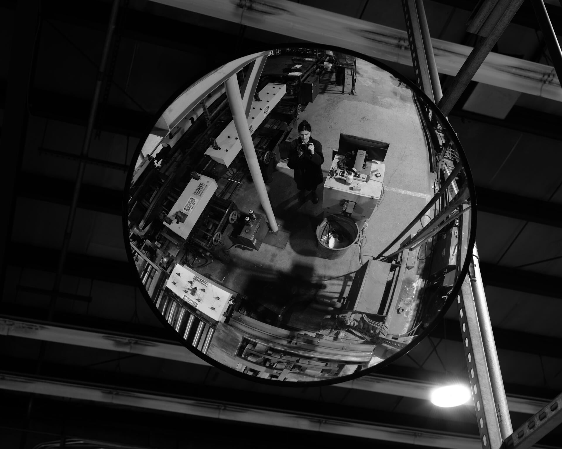 Black and white portrait from within an industrial manufacturing center.