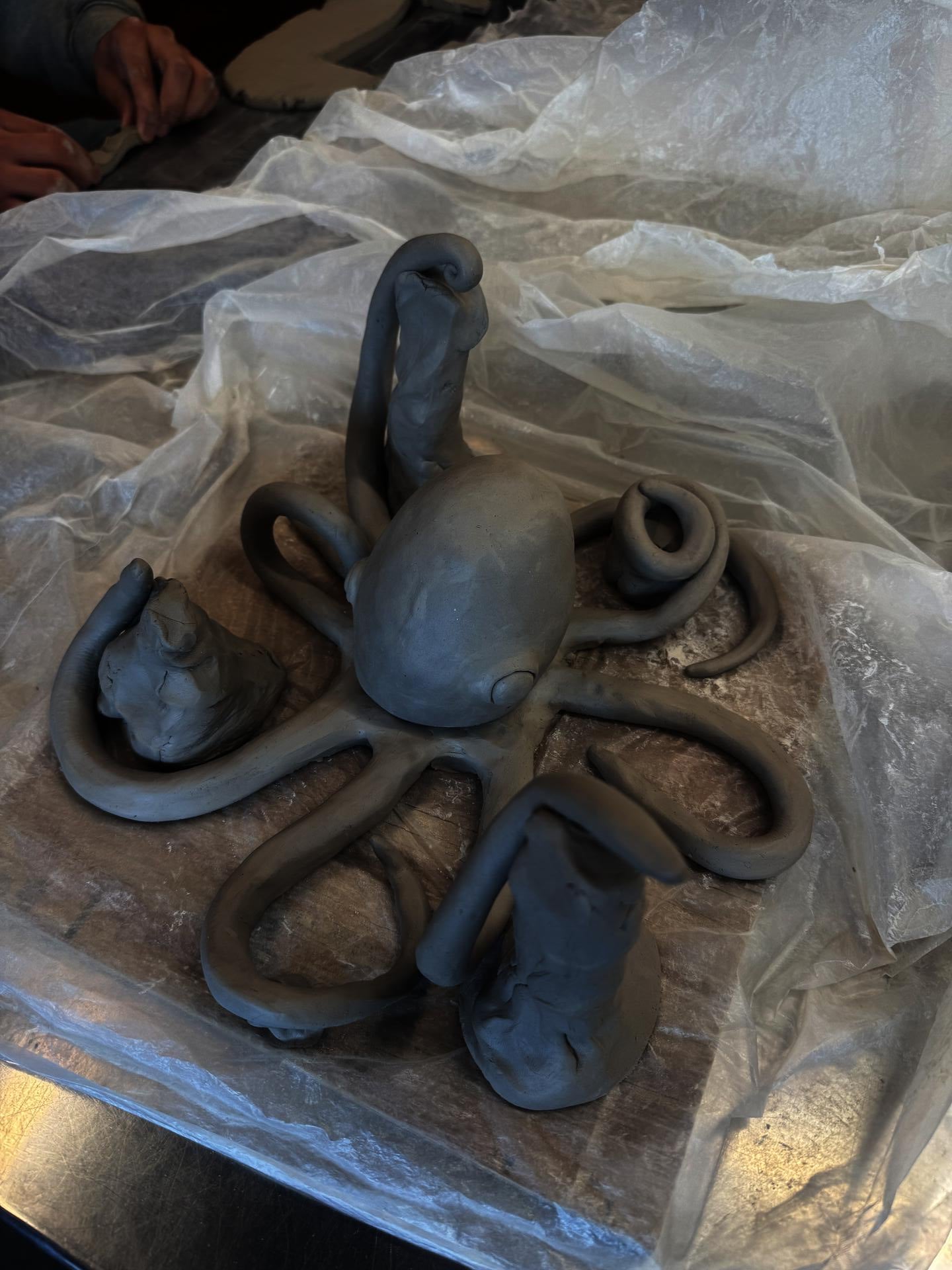 A student out of frame carves an octopus to be able to hold and display medals and other sports awards