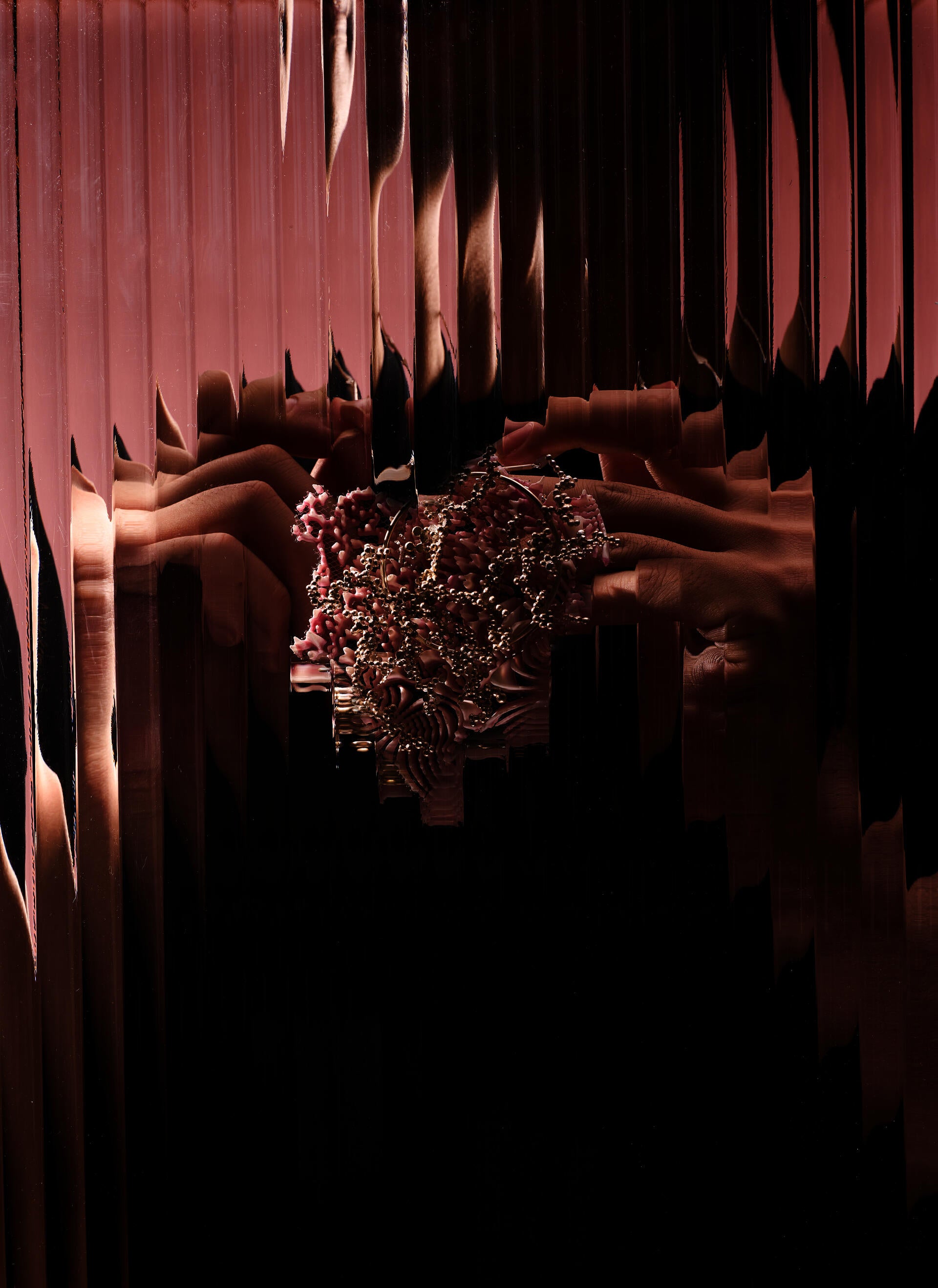 Small pink pendant covered with a network of silver granulation tracing lines across its textured surface.