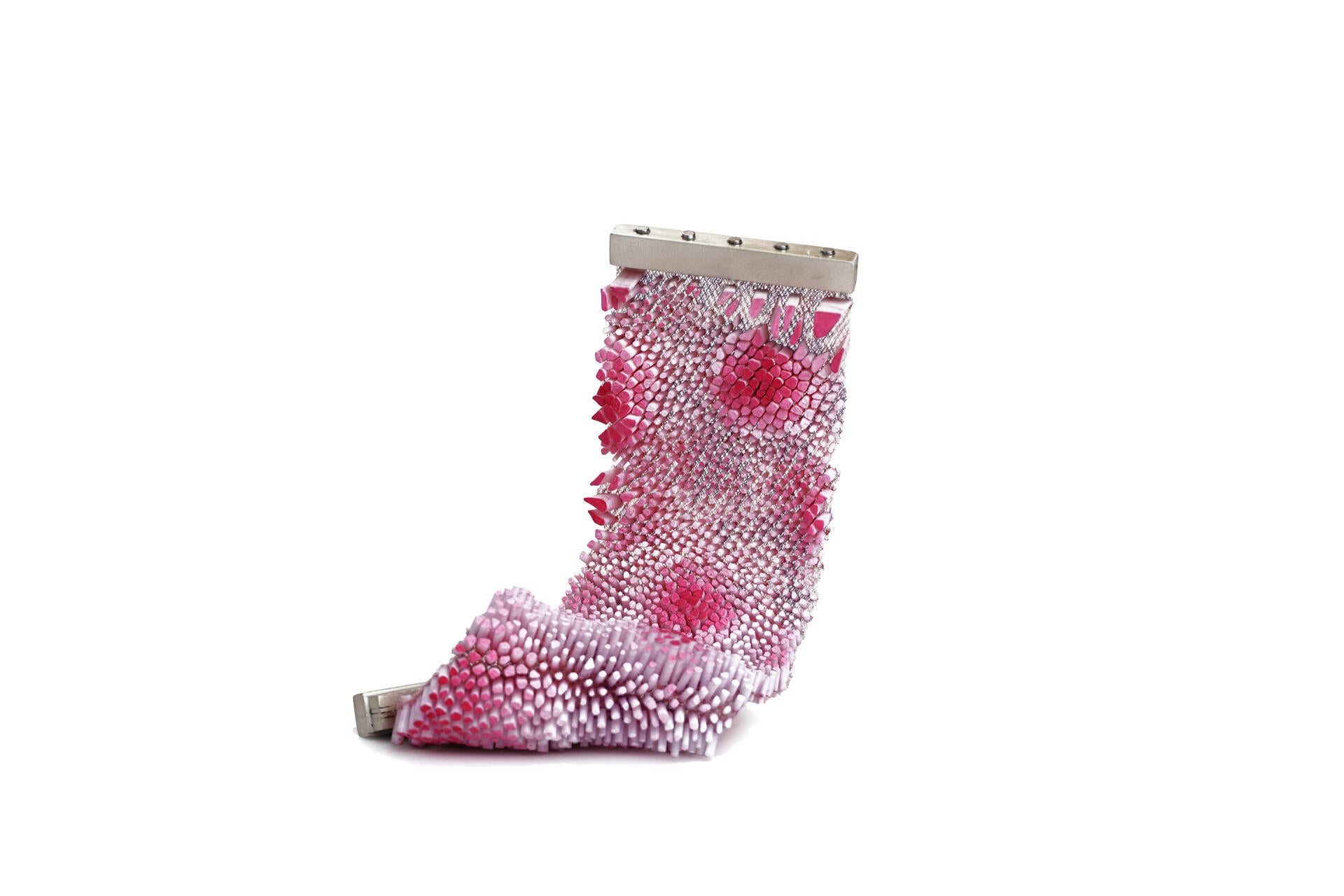Pink bracelet covered in densely packed small upright elements on mesh, with darker pink areas creating depth variation.