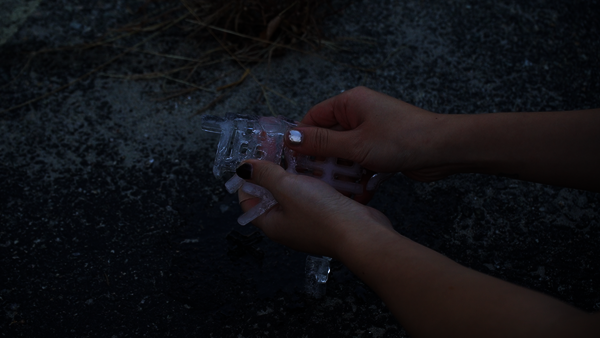 Hands centered, continuously melting the ice held within them; the ice is shaped into the Chinese text: “Where are you?”
