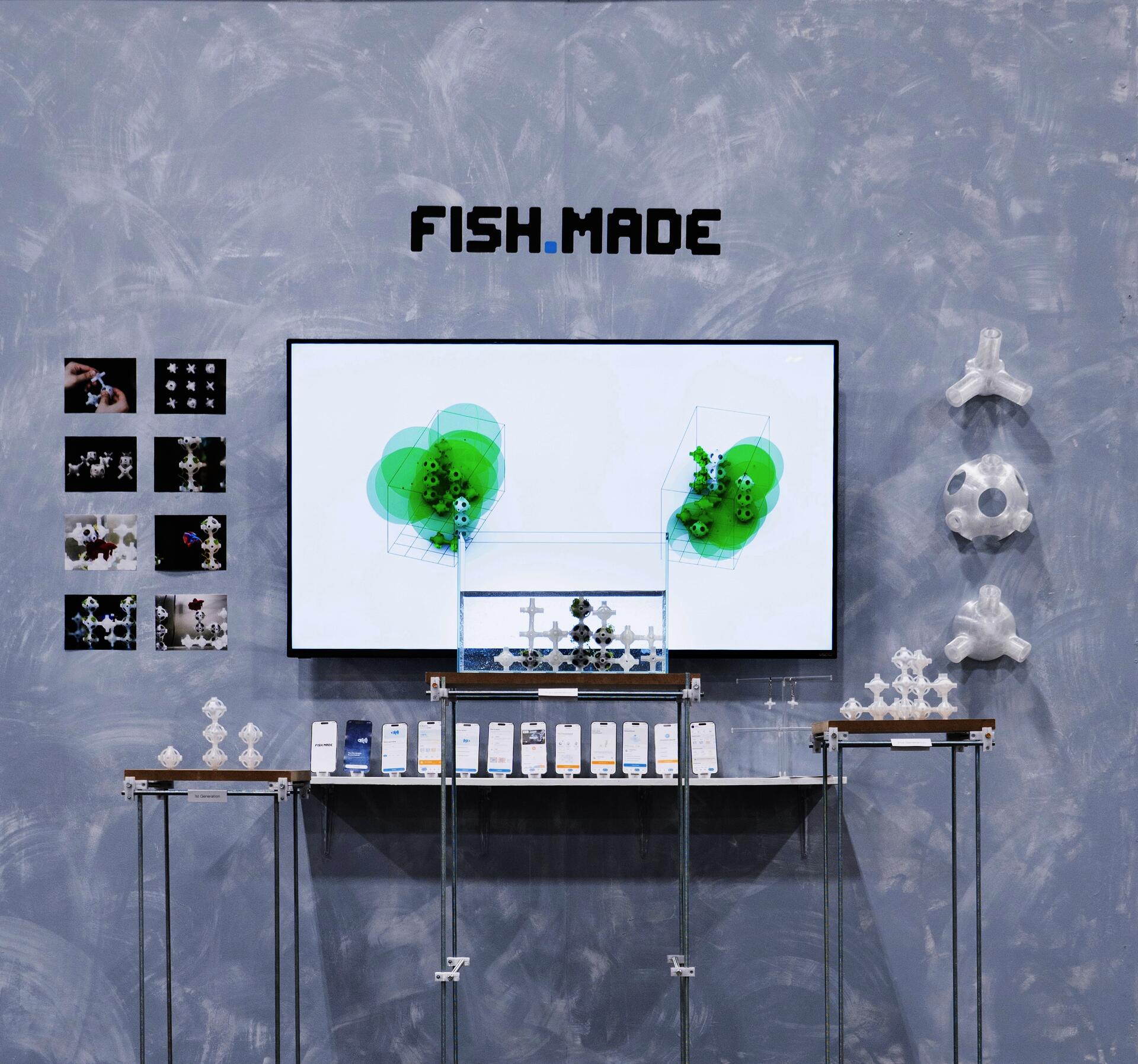 FISH.MADE installation showing the final modular fish habitat inside the tank, with prototype images, app screens, and 3D-printed modules displayed around the screen.