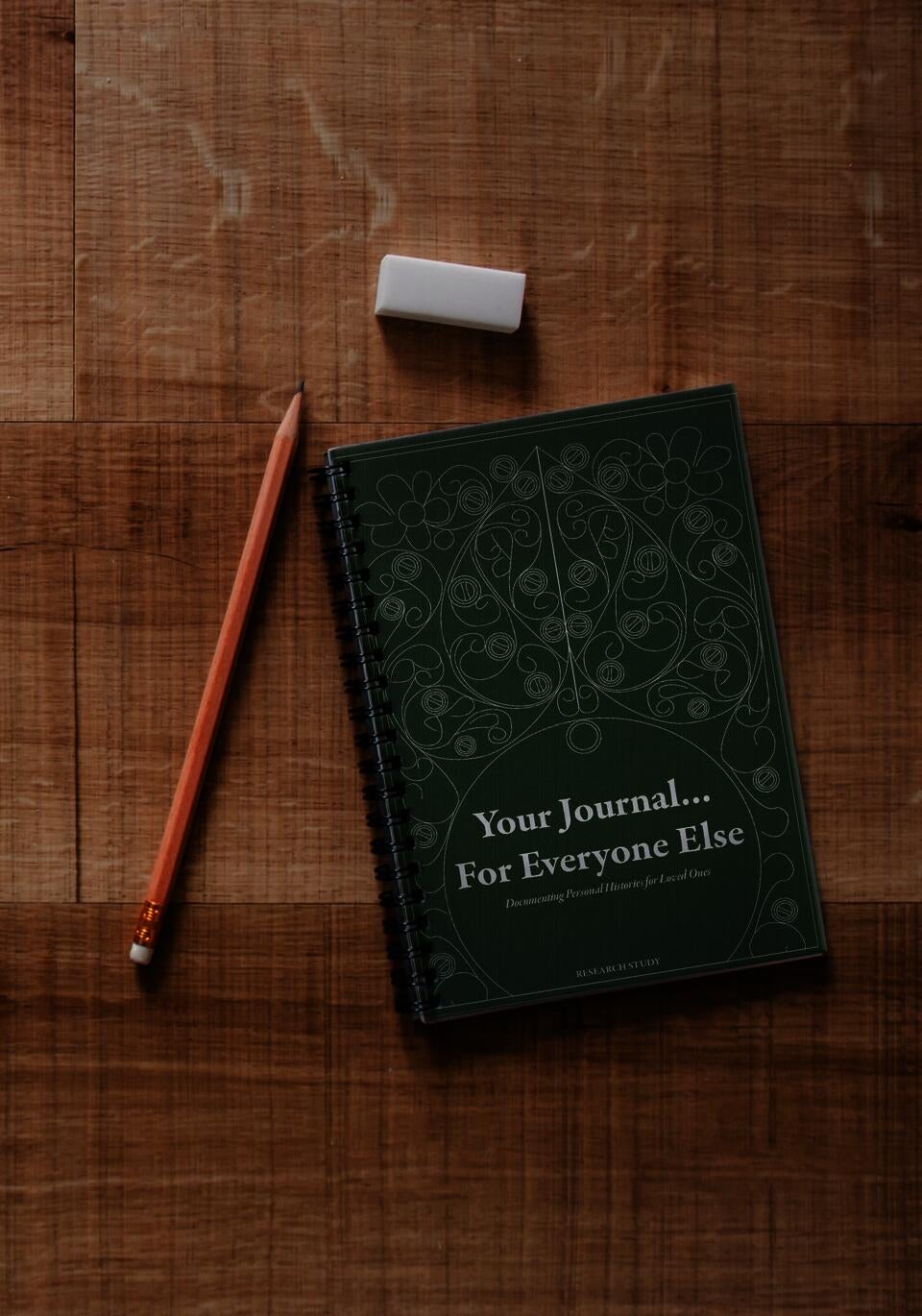 Journal on table with pencil.