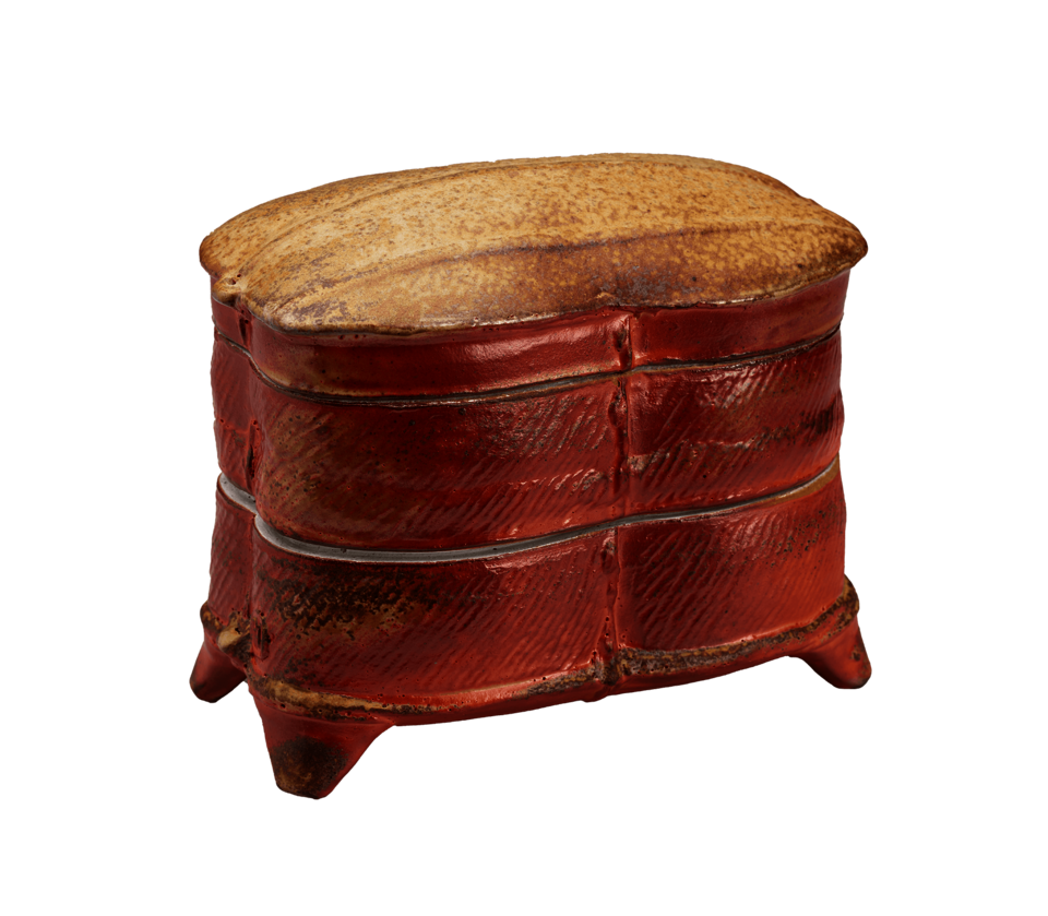 A rust-colored box with horizontal bands, triangular feet, and a tan top